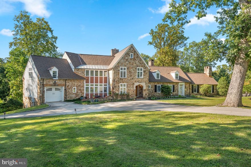 Welcome to 659 Andover Road, a truly exceptional property. This handsome stone manor home immediately captivates with its breathtaking curb appeal and is nestled on 3.15 acres in the premier estate section of Newtown Square. Here you are just steps from Aronimink Golf Club & Episcopal Academy, and 5 minutes to downtown Wayne & the Newtown Town Center. This expansive Archer & Buchanan designed home boasts 6 Bedrooms, 4 Full, 3 Half Baths, and 6,350 sq. ft. above grade and 9,975 sq.ft. total including the finished lower level. 
As you approach the majestic front door, take note of the NEW CertainTeeds’s Grand Manor architectural shingle roof with copper flashing that was just installed this summer! Step into the elegant family room which serves as the heart of the home with timeless coffered ceilings and floor to ceiling French doors that flank the show- stopping fireplace. This room flows effortlessly into a spacious kitchen which has been tastefully updated in 2025 with quartz counter tops & backsplash, lighting fixtures, high-end appliances, and freshly painted custom cabinetry. French doors in the kitchen lead to a massive deck, built in 2020, which offers a covered outdoor space complete with a gas fireplace and an inground pool, creating an ideal setting for outdoor entertaining. Through another set of French doors is the expansive yet intimate dining room.  Continuing through the home, the gorgeous hardwood floors lead to a light-filled office as well as a home library with custom-built cabinetry, both spaces provide the perfect tranquil setting for privacy & focus. An additional front door entrance allows for separate access for professional use if so desired and is adjacent to the office & library as well as the back staircase. Completing the first floor is the star of the home; an extensive vaulted-ceiling pub/game room, offering versatile space that oozes with character and charm.  
The main staircase ascends to the spectacular primary bedroom, which showcases a true sanctuary, boasting vaulted ceilings, a stunning array of windows, sitting area, two spacious outfitted walk-in closets and a luxurious en-suite bath with dual vanities, jetted tub, and an oversized walk-in shower. On the same level, there are four additional bedrooms and two bathrooms. The third floor offers a sixth bedroom with its own bathroom, providing a beautiful private suite perfect for visiting guests or an au-pair. The fully finished lower level of the home includes convenient access to the additional two rear garage bays, with back stairs leading directly into the mudroom. This walkout lower level features a large family room ideal for movies and games, a kitchenette, bonus room and a home gym. With neighboring properties selling up into the $3M+ price range, you don't want to miss this opportunity to call 659 Andover Road your home.