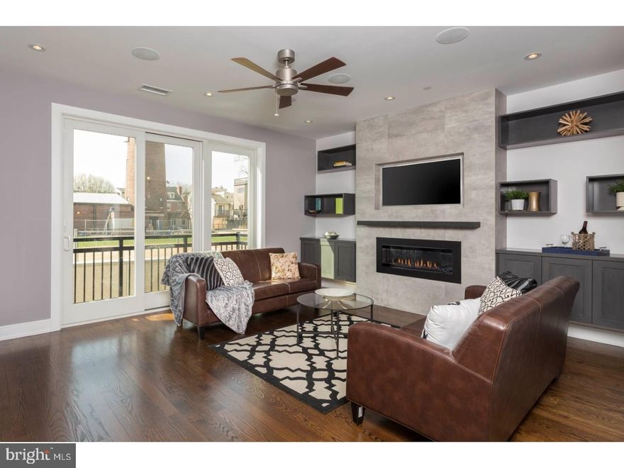 There are just 2 townhomes left! This 4,500 sq. ft. LUXURY home is found at Shot Tower Estates; a 9 unit, new construction GATED development which offers 4 Bedrooms, 3 Full Baths, 2 Powder Rooms, an ELEVATOR and 2 CAR GARAGE parking in Queen Village. Select gorgeous finishes throughout the 19' wide home to create a custom feel. The first floor offers a stunning floating steel staircase, 2 car Garage and Bedroom; great as a home office, located off the front entry with a powder room conveniently concealed. Downstairs, the finished Basement is great for a Guest Suite, In-Law suite, Media room or Gym with high ceilings, a full Bathroom and custom built wet bar with wine frig. Upstairs, the open floor plan was designed with entertaining in mind with a surround sound system, a Living Room with a stunning gas fireplace as the focal point with a tile surround and stone mantle. The professionally designed Chef's Kitchen showcases custom-built cabinetry, an island with bar seating, stone counters, a Wolf/Sub Zero appliance suite with cooktop, stainless floating hood, wall oven, microwave and features cove & under cabinet accent lighting and backsplash. Step outside to a rear deck; excellent for your grill and outdoor dining. The Dining area sits alongside the Kitchen as well as a Powder room; great for hosting dinner parties! The 3rd Floor features 2 large Bedrooms, a full Bath and Laundry room with sink, folding counter and upper cabinetry. 4th floor Master Suite is pure luxury with a gas fireplace in the Bedroom area, THREE walk-in closets and a Spa-like Master Bath with an oversized shower (multiple shower heads), a freestanding soaking tub, heated floors, and a custom double vanity. The pilot house offers a wet bar for serving cocktails while enjoying Fireworks and Sunsets seen from the huge roof deck with outdoor audio and 360 degree views of the city! Whole House audio, 2 alarm key pads, video intercom system and LED lighting throughout are just some of the intricate smart home features that are offered. Oak, stained in place hardwood floors, ample closet space and huge windows for natural lighting add to this custom mini mansion in the heart of Queen Village. Walking distance from many restaurants, bars, cafes, Shot Tower playground/Rec Center and the Delaware River Waterfront. 10 yr tax abatement pending. If you're looking for a QUALITY built home, once inside, you'll discover the extraordinary craftsmanship. Still time to pick your own finishes.