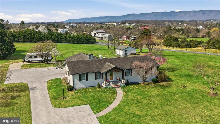 Fully Remodeled Estate on 1.68 Level Acres – The Ultimate Retreat
The Interior:
Step into a home that FEELS brand new. Completely remodeled in November 2020, this 2,573 sq. ft. residence features a modern open-concept main level with durable LVP flooring, quartz countertops, a large island, and 6-year-old appliances. The primary suite is a true sanctuary, boasting a massive walk-in closet and a spa ensuite with ceramic floors, a soaking tub, and a custom tile walk-in shower with dual shower heads. Three additional bedrooms offer incredible flexibility, including one with direct "suite-style" access to the full hall bathroom.

The Bonus Space:
 The basement is a true "bonus," offering 1120 sq ft of finished space and 332 sq ft of unfinished space that includes 2 storage rooms w/shelving and a work room.  The finished space features a sink, drink cooler, and woodstove—two other very large finished rooms give many options to this versatile space!

For the hobbyist, the property includes a 24x24 detached outbuilding with electricity, plus a 2-car attached garage that is fully climate-controlled with its own dedicated LP gas HVAC system.  Parking for large gatherings is no problem!  There are oodles of concrete areas for cars, RV parking, boat, etc…or a really fun place for the littles to ride bikes and play!

The Outdoors:
Relax on your usable 1.68-acre, 100% level, all-grass lot. This is a RARE find.  There is a large fenced area for furry friends and perhaps the start of your dream farmette?  The exterior (painted in 2022) is complemented by outdoor living spaces, including lighted patio areas and a charming lighted gazebo—perfect for evening gatherings.  You will be delighted to see Spring wake up all the beautiful flowers on the property!  The mountain views are incredible.

Infrastructure & Peace of Mind:
No detail has been overlooked regarding maintenance and efficiency:
•