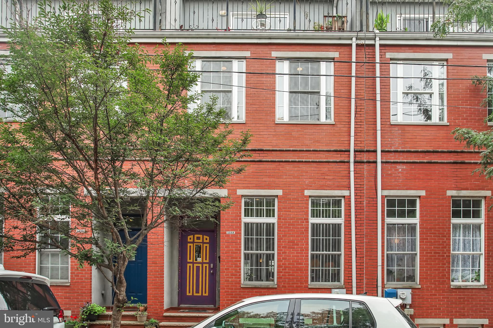Welcome to 1233 N Howard Street, a massive 5 bedroom/3.5 bathroom home with 2 car parking! Located just north of Girard Ave in Olde Kensington right on the border of Fishtown. This extremely unique home is within walking distance of Laser Wolf, Pizzeria Beddia, Front Street Cafe and all of the restaurants and nightlife that Fishtown and Northern Liberties have to offer! Enter in to the main floor where you will be taken back by a sprawling open floor plan with 15+ foot ceilings! The main level showcases a living room and a dining room that leads you to the spacious kitchen with island. The half bathroom is situated conveniently right off of the kitchen area. Looking out the back window from the kitchen you will see the patio area as well as the driveway with enough room for 2 car parking! Never worry about parking again in Fishtown! As you head downstairs to the fully finished basement you will find not one, but two washer/dryer sets and an expansive bonus/media area. A full bathroom can be found right off the bonus room which is perfect for the basement bedroom. Right off the that second living room area is the basement level bedroom with a full walkout to the back patio. The second floor of the home reveals two more large bedrooms and a full bath with a double sink. Heading upstairs one more level to the third floor you will find two more bedrooms draped in natural light from the windows. The front bedroom also features an outdoor porch/sitting area! The 3rd full bathroom is also on the third floor and showcases a double sink as well. There are must see towering high ceilings throughout the home. This is a great opportunity for a large family or even an investor looking to utilize the unique space for long or short-term rentals. Schedule your showing today!!