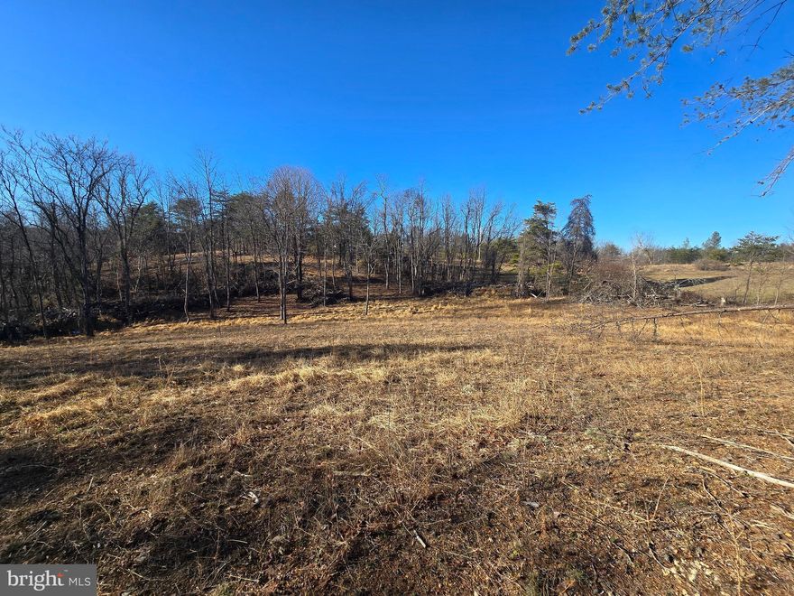 BEAUTIFUL BUILDING LOT - IDEAL LOT FOR YOUR DREAM HOME!!! This 2.025 acre lot is partly wooded with a gentle slope and clear section ready for building.  The property has a perc test approved for a three-bedroom septic system.  The lot is situated along a paved, state/county maintained road providing easy access.  Situated less than 10 miles from downtown Berkeley Springs/Town of Bath with all of its shops, spas, and restaurants.  Convenient to town, but with that "out in the country" feel!  Bring your house plans and come build your dream home in West Virginia!