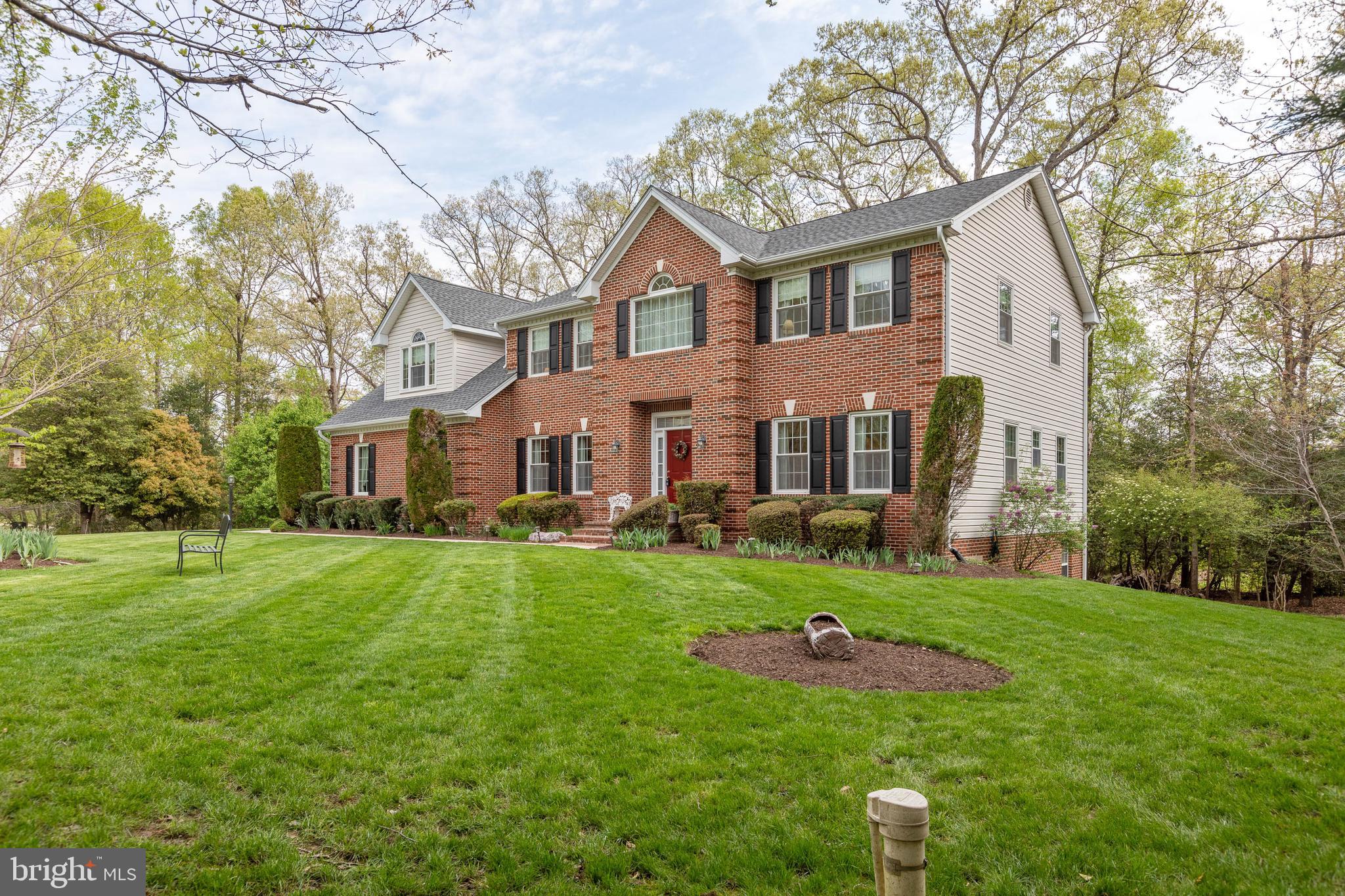 Stunning home on well manicured lot. Relax on the Huge Deck in your Hot Tub. Tastefully decorated throughout. Large Kitchen with Island and Breakfast Nook. Downstairs In-Law Suite with Full Kitchen. Move In Ready. Great Commuter Location. Close to Schools and Shopping. Possible 6th Bedroom in Basement.