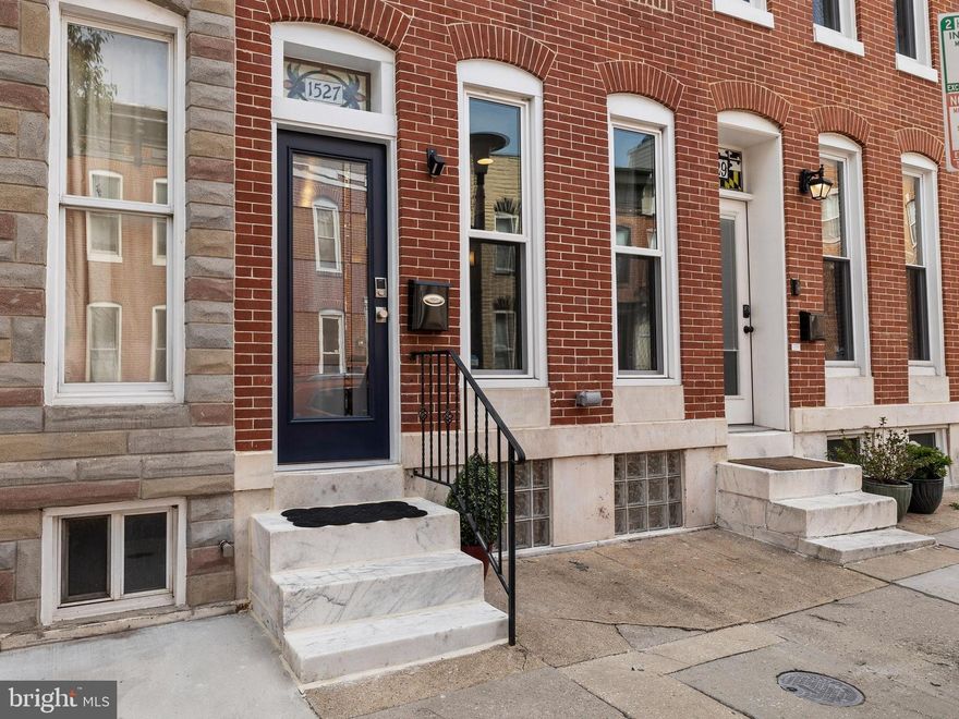 Welcome to 1527 Marshall Street – This updated Federal Hill rowhome features 3 finished levels with 2 bedrooms, 2 full / 2 half baths, roof deck, and off-street parking!  The large open floor plan on the main level is highlighted by exposed brick, hardwood floors, and a custom open riser staircase.  The spacious living room is only topped by the beautiful and well-designed kitchen that offers stainless steel appliances, granite counters, and a large pantry (New Fridge 2019, New Dishwasher 2021).  The dining room is located at the rear of the home and can easily accommodate a large table.  The main level is completed with a powder room and a coat closet, which are not typically found in many rowhomes.  The bedroom level consists of two sizable bedrooms, two full bathrooms, and the laundry closet.  The primary suite is located at the rear of the home and includes a private bathroom with a massive shower with a skylight.  Centrally located stairs provide access to the roof deck which is ideal for entertaining and taking in the skyline views (New Roof 2022).  The lower level is fully finished and is completely versatile (home office, home gym, playroom, man cave, or occasional guest space).  To top it all off this home includes a private patio space off the main living level that is followed by an oversized parking pad for 1 car.  Additional highlights: New  Windows, New Front Door & New Roof Deck Door - 2019