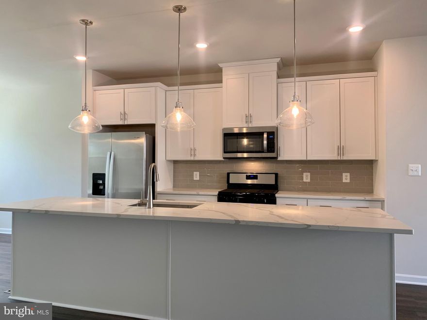 AVAILABLE NOW! Beautiful Addison plan fully finished and ready to move in. Get ready to fall in love with this gorgeous kitchen - white marbled quartz counters, glass subway tile backsplash, stainless steel appliances, and modern pendant lights over huge center island. Spacious great room leads to Trex deck perfect for grilling. Owners suite boasts a frameless shower door with high end ceramic tile and quartz countertops. Full Brick front, facing a scenic tree preserve. Best of all, you are just a short walk away from entertainment, dining and the VRE in the heart of historic Old Town Manassas! Special Financing available - with rates as low as 4.99% for a limited time!