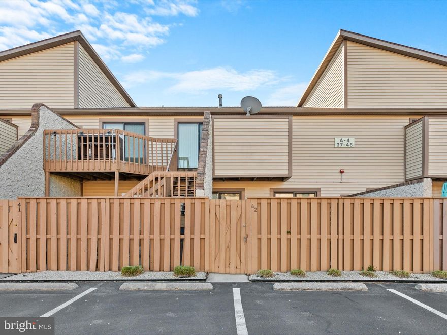 Discover the perfect blend of comfort, style, and location in this beautifully maintained 2-bedroom, 2-bathroom ground-level condo in the sought-after Club Ocean Villas II community in North Ocean City. Offering modern updates, thoughtful design, and the ease of one-level living, this home is the ultimate coastal retreat. Step into the inviting living room, where soft carpeting, a ceiling fan, and natural light from the sliding glass door create a relaxing atmosphere. The door opens to your private patio, a peaceful outdoor escape surrounded by a wood privacy fence—perfect for morning coffee or evening relaxation. The kitchen is both functional and charming, featuring durable vinyl flooring, electric cooking, a built-in breakfast table, and a pantry to keep everything organized. Tucked away behind a stylish mirror-front folding door is an in-unit stacked washer and dryer, installed in 2021, providing seamless functionality without sacrificing aesthetics. The primary bedroom is a tranquil retreat with plush carpeting, a ceiling fan, and an attached bathroom featuring a tub-shower combo. The second bedroom offers its own sliding glass door to the patio, making it perfect for guests or a flexible workspace. The second full bathroom includes a walk-in shower and a luxurious soaking tub for unwinding after a long day. This move-in-ready condo includes all items conveying with the sale and recent updates such as a new oven (2024), a dishwasher (2019), and upgraded bathroom fixtures installed in 2021. Living in Club Ocean Villas II means enjoying an impressive array of amenities, including indoor and outdoor pools, a recreation center, tennis and pickleball courts, and a pier and dock for water enthusiasts. Whether you’re swimming laps, playing a game, or simply enjoying waterfront views, there’s something for everyone. Conveniently tucked behind Food Lion, this condo offers effortless access to daily necessities. Just steps away, Northside Park, Ocean City’s largest park, provides walking paths, a playground, sports fields, and a scenic pier. The park also hosts year-round events like the Winterfest of Lights, making it a hub of community activity. The pristine beach is only minutes away, offering opportunities for sunbathing, swimming, or peaceful morning walks along the shore. Nearby, you’ll find diverse dining options, from fresh seafood to cozy cafes, ensuring something for every palate. This property is more than a home—it’s a lifestyle of comfort, convenience, and coastal living. Whether you’re seeking a year-round residence, vacation getaway, or a smart investment, this condo in Club Ocean Villas II is ready to welcome you. Schedule your private tour today and experience the charm and possibilities of this exceptional Ocean City gem. One-level living has never looked so good!