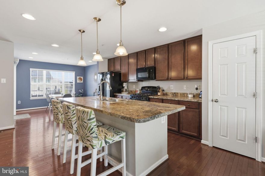 This move-in ready townhome offers three levels of comfortable and versatile living with 3 bedrooms, 2.5 bathrooms, and a garage. The entry level welcomes you with a bright foyer and a family room. This level also offers convenient interior access to the garage.

The main living level is designed for everyday living and effortless entertaining. The open floor plan centers around a spacious kitchen featuring a large island with breakfast bar, ample cabinetry, hardwood floors, and generous counter space. The kitchen flows seamlessly into the dining area and expansive living room, creating an inviting space for gathering. A convenient half bath completes this level.

The upper level provides a peaceful retreat with a private primary suite offering a walk-in closet and en-suite bath. Two additional bedrooms and a full hallway bath provide comfortable space for family or guests.

Ideally located just minutes from major highways, shopping, and dining, this home also offers access to community amenities including beach area, a dog park, and local favorites like the Hard Yacht Café.