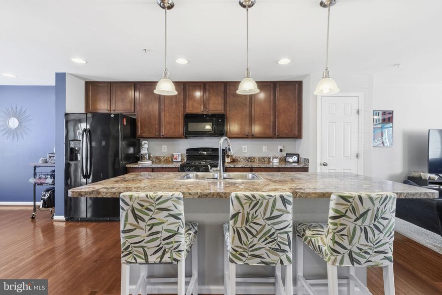 This move-in ready townhome offers three levels of comfortable and versatile living with 3 bedrooms, 2.5 bathrooms, and a garage. The entry level welcomes you with a bright foyer and a family room. This level also offers convenient interior access to the garage.

The main living level is designed for everyday living and effortless entertaining. The open floor plan centers around a spacious kitchen featuring a large island with breakfast bar, ample cabinetry, hardwood floors, and generous counter space. The kitchen flows seamlessly into the dining area and expansive living room, creating an inviting space for gathering. A convenient half bath completes this level.

The upper level provides a peaceful retreat with a private primary suite offering a walk-in closet and en-suite bath. Two additional bedrooms and a full hallway bath provide comfortable space for family or guests.

Ideally located just minutes from major highways, shopping, and dining, this home also offers access to community amenities including beach area, a dog park, and local favorites like the Hard Yacht Café.