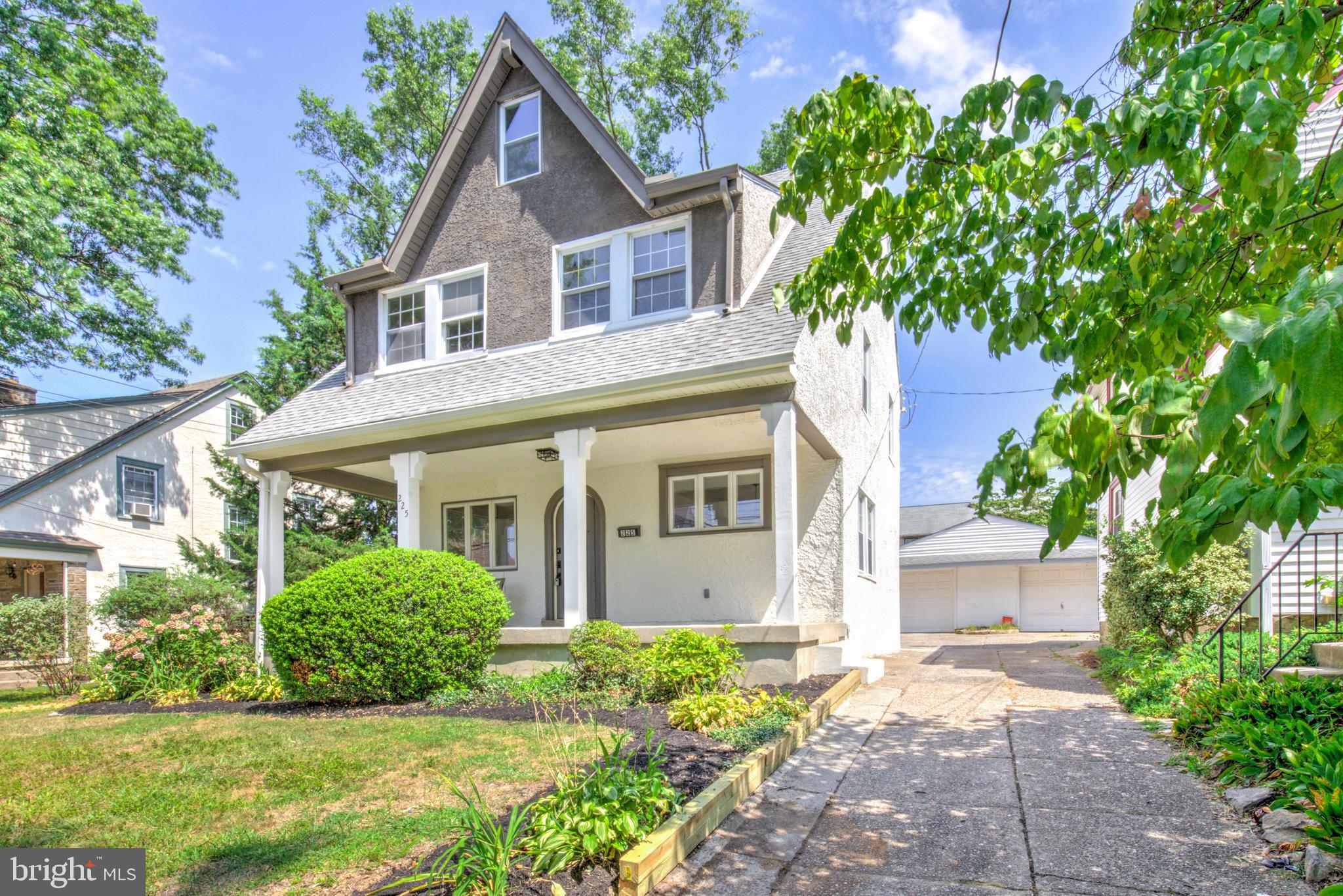 Welcome to this beautifully renovated and spacious 5-bedroom, 3.5-bathroom home with one car garage nestled in a peaceful residential neighborhood in Springfield. With its European-style stucco exterior, steeply pitched roof, and inviting wooden arched front door, this home offers distinctive curb appeal and timeless charm—all just minutes from major highways and the vibrant Greater Philadelphia area. Step inside to discover an open-concept main floor that effortlessly blends classic character with modern updates. Gleaming refinished hardwood floors, an original stone fireplace, and a striking wood staircase create a warm and welcoming atmosphere. The fully updated kitchen features sleek white cabinetry, quartz countertops, a tile backsplash, and stainless steel appliances—perfect for both everyday living and entertaining. A convenient mudroom at the rear of the home provides main floor laundry and a new powder room for added functionality. Upstairs, the elegant second level boasts three generously sized bedrooms and three full bathrooms, including two ensuite suites. The luxurious primary suite includes a sunlit bedroom and a spa-inspired ensuite bath with a walk-in shower, soaking tub, and double vanity. The third floor offers two additional spacious bedrooms, each with unique ceiling lines that add architectural interest and charm. Additional features include a brand-new, energy-efficient electric heat pump HVAC system for year-round comfort. Don't miss your chance to own this one-of-a-kind home that blends Old World character with modern convenience in one of Springfield's most desirable locations!