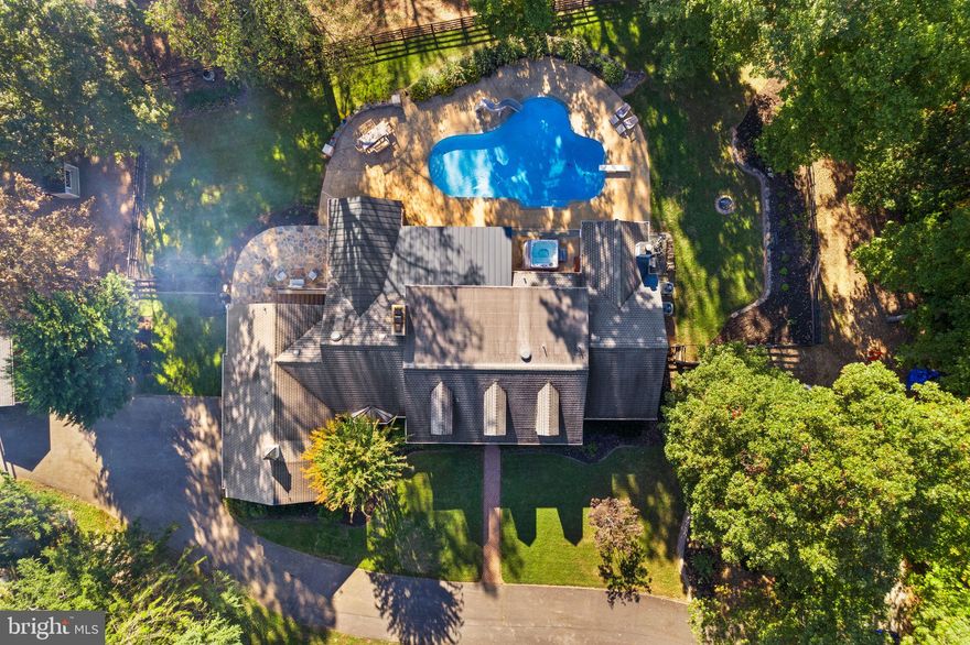 What a place to call home! Multi-generational living on five private acres this 6,500+ square-foot, 6 bedroom, 5 full and 2 half bath home redefines the meaning of functional elegance. Main level primary suite with a full basement apartment, equestrian facilities, pristine pool and MORE,  all located just minutes from major commuter routes, shopping, dining and the historic town of Clifton.
The main level of this home offers a true gourmet kitchen (think double sinks, double ovens and double dishwashers!) with a plethora of cabinets, built-in island seating, breakfast space and a bucolic view into the rear yard. Made for entertaining, the dining room, family room and living room are spacious and inviting. Fireplaces, built-in bookshelves, a handmade fireplace mantle, french doors to the covered patios, you've got to experience this space in person! The bedroom wing of the main level features the luxurious primary suite with attached spa-like bath and sunroom, complete with gas fireplace and access to the hot tub and swimming pool.  The functional walk-in closet is the cherry on top! Two additional bedrooms, one with an ensuite bathroom and full hall bath complete the main level. Upstairs you'll find a cozy loft, two huge bedrooms, a bathroom with double sinks and craft room.  The basement has something for everyone! Watch a movie, catchup with friends, play a game of pool! Don't miss the half bath off the rec room. But wait...there's more! Tucked away, with it's own outside entrance is a FULL basement apartment with separate kitchen, bedroom, living area, bathroom and laundry. The possibilities are endless! The property has been lovingly cared for with the recent addition of retaining walls, flagstone patio and professional landscaping. Your 4 legged family members will appreciate the two stall shed row barn with tack room, additional separate pony barn, paddock, hay barn, outdoor arena and cross country jumps in the front yard. Notable updates include HVAC units replaced in 2023 and 2024, tankless water heater upgrade and modernized septic. Don't miss out on this once in a lifetime opportunity!