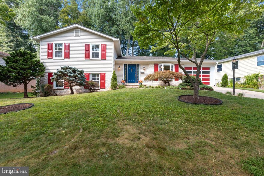 Welcome to this beautifully renovated split level home on one of the prettiest lots in the Highly Desirable Manor Woods Subdivision.  This home features Wide entry FOYER features large coat closet, large shelved pantry, ceiling mounted designer light fixture, travertine tile flooring and front door with leaded glass sidelights.  Lovely LIVING ROOM features crown molding, recently updated full-wall picture window with double-hung side windows, refinished hardwood oak flooring. DINING ROOM features crown molding, chair rail, chandelier, refinished hardwood oak floor, recently updated sliding glass doors accessing Nicolock paver Patio and gorgeous rear yard, open entry to Eat-In Kitchen and Living Room. Renovated EAT-IN KITCHEN features solid cherry wood cabinetry with pull-out drawers, stainless side-by-side refrigerator/freezer with ice-and-water dispenser, self-cleaning double wall ovens (top oven: convection), stainless five-burner gas cook-top, overhead exhaust hood, stainless dishwasher, stainless steel sink with soap dispenser, solid quartz counter-tops, under cabinet lighting, tile back splash, travertine tile flooring, mobile center island with butcher block counter-top, monorail track lighting, large bay window with casement openings, ceiling fan chandelier, door accessing thirty-four foot very deep one-car Garage, open entry to Dining Room and entry to Foyer.
The PRIMARY BEDROOM on UPPER LEVEL 1 features two double-hung windows, large walk-in closet,  and Renovated full bath. Improvements include vanity with cultured marble counter top and brushed nickel fixtures, over-sized shower with shelved shower surround and glass enclosure, designer light fixture, ceramic wall tiles, and LVP tile flooring. SECOND FULL BATH features wide custom vanity with drawers, cultured marble counter top and brushed nickel fixtures, shower/tub combination with tub surround, multiple lighting system, and waterproof luxury vinyl tile flooring.

LOWER LEVEL 1 boasts a wonderful RECREATION ROOM with gas fireplace (easily converted back to wood-burning) with brick profile/hearth, custom hardwood oak mantel and glass doors, large custom built-in cabinetry, and BRAND NEW wall-to-wall carpeting, Renovated Half bath features designer vanity sink, designer wall covering, designer lighting fixture, and waterproof luxury vinyl tile flooring. Here we also have a FIFTH BEDROOM with built-in lighted cabinetry, recessed lighting, walk-in closet with adjoining cedar closet, and independent exterior door accessing side yard, ideal for HOME/OFFICE or IN-LAW SUITE. 
In LOWER LEVEL 2 you find a large STORAGE ROOM Laundry Facilities with large capacity washer/dryer stainless steel utility sink, work bench, pegboard wall storage, large walk-In Storage Closet.
This home has an ideal floor plan provides for both entertainment space and comfortable living. The gorgeous rear yard is framed by mature trees and specimen plantings with ample garden space. The home is conveniently located near local shopping, pool, schools, public transportation, minutes to Rockville Town Center, the ICC, and Metro. 
WELCOME HOME!