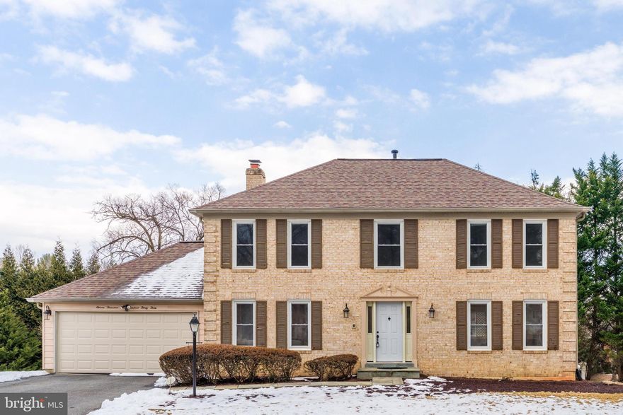 Beautifully maintained and thoughtfully updated, this spacious home features hardwood floors throughout the main level and a functional, light-filled layout. The welcoming foyer opens to formal living and dining rooms, while the kitchen offers custom cabinetry, glass tile backsplash, and stainless Whirlpool appliances, including a five-burner gas range. A bright breakfast area with deck access flows seamlessly into the cozy family room with a wood-burning fireplace and brick surround. A laundry/mudroom with garage access completes the main level. Upstairs, the primary suite includes custom blinds and a private en-suite bath with dual vanities and a tiled shower with bench. Three additional bedrooms share a well-appointed hall bath with double vanity and tub/shower combination. The fully finished walk-out basement provides exceptional additional living space, featuring a large recreation area with wet bar, a private guest suite with full bath, bonus room ideal for office or gym, abundant storage, and direct access to the rear patio with stairs leading to the deck. A two-car garage adds everyday convenience.