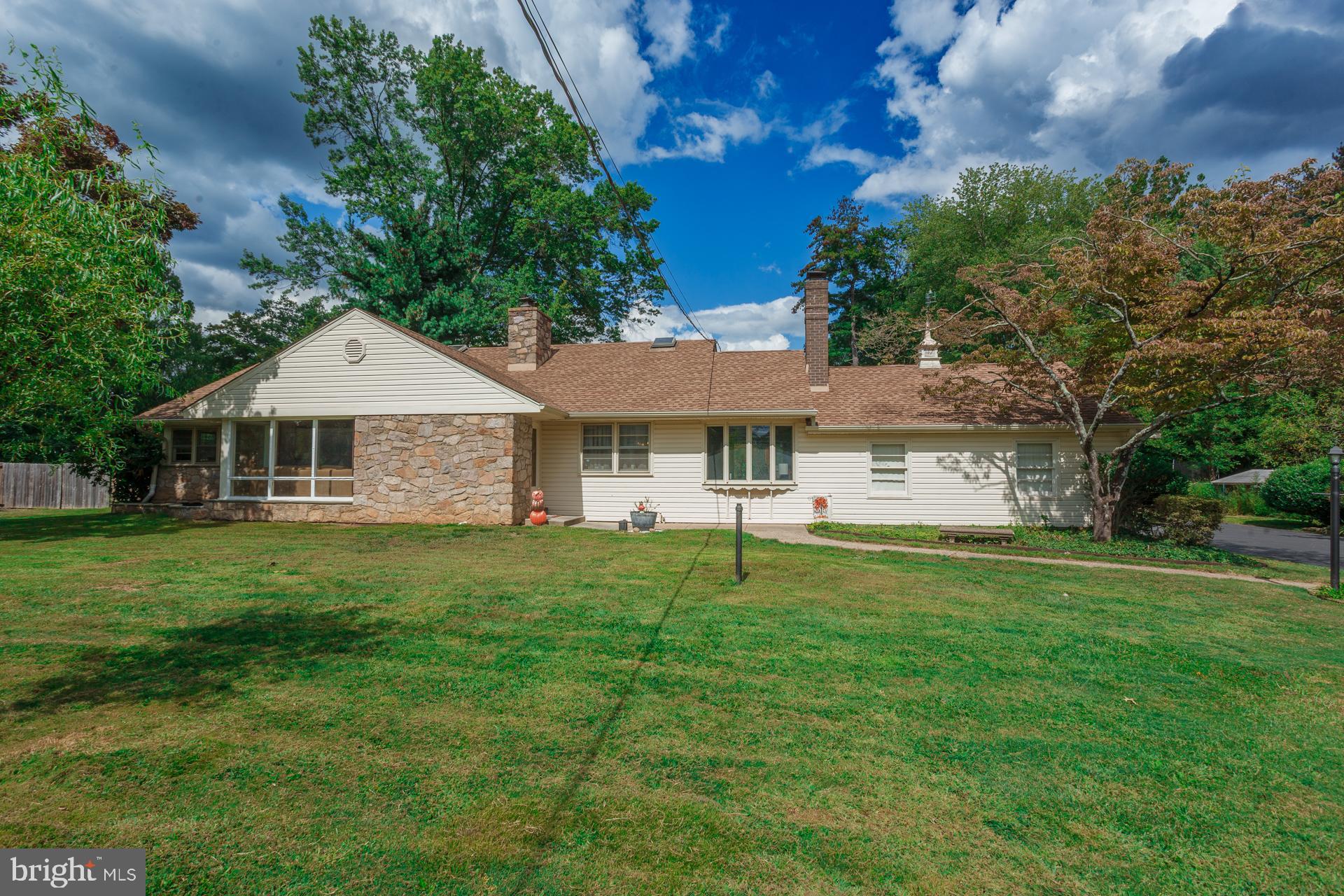 Spacious Custom Ranch with Second-Floor Addition in Council Rock School District. Discover this beautifully crafted ranch-style home with a flexible second-floor addition, located in the highly regarded Council Rock School District. Featuring 5 bedrooms, 3 full bathrooms, and 4 garage spaces (2 attached, 2 detached), this home blends comfort, convenience, and timeless charm. Inside, a sun-filled living room welcomes you with dramatic floor-to-ceiling windows and a cozy wood-burning fireplace. A formal dining room connects seamlessly to the family room, creating the perfect gathering space. The kitchen, enhanced by skylights, offers abundant natural light and a warm, inviting atmosphere for cooking and entertaining. The main level offers the ease of one-floor living with three bedrooms, including a spacious primary suite, two additional bedrooms with ample closets, and two full baths. One bedroom was converted into a laundry space, but the setup could be relocated to the basement where the original hookups remain. The second floor features two more bedrooms, a full bath, and access to a large walk-in attic with a whole-house fan—providing plenty of storage or potential for expansion. Perfect for hobbyists, collectors, or car enthusiasts, the property includes four garage bays. The oversized detached garage also boasts a second-level space—ideal for a workshop, studio, or additional storage. Outdoors, enjoy a charming back patio overlooking the fully fenced, expansive yard, perfect for entertaining, gardening, or simply relaxing in your own private retreat. Recent updates include a professionally waterproofed finished basement, a chimney treated with Heatseal ceramic coating with a 20 year warranty, and a new well and Water softener, giving you added peace of mind. This exceptional property offers space, versatility, and a prime location in a top-rated school district. Don’t miss the chance to make it yours!