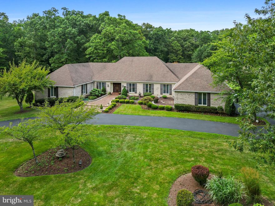 MAJOR PRICE IMPROVEMENT! OVER $100,000 BELOW APPRAISED VALUE! SALE INCLUDES AN ADJACENT 5-ACRE BUILDING LOT THAT IS APPRAISED AT $265,000!

Welcome to your dream home! This impeccably maintained custom-built residence stands out as a true one-of-a-kind gem. Spanning nearly 9,000 square feet of finished space, the main level boasts four spacious bedrooms and three luxurious full bathrooms, ensuring comfort and convenience for all. 

Venture downstairs to discover a fully finished basement with a second kitchen, a fourth full bathroom, and a custom bar—perfect for entertaining guests or family gatherings. Seamless transitions connect upper and lower outdoor entertaining areas, inviting you to soak in the beauty of your perfectly maintained grounds and manicured landscaping. 

Additional highlights include a detached two-car garage, a separate 5-acre building lot included with the property, several charming outbuildings, and countless meticulously curated details by the owners. This magnificent property is not just a home; it's a lifestyle waiting for you to embrace. Don't miss your chance to call it your own!