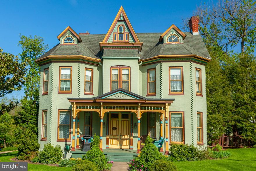 PRICE REDUCTION The HC Berry house Circa 1890  is a Glorious Historic Large  Brick Victorian Painted Lady on a street with many other fine homes.  Perfect for Air B&B or short term rentals.  It is colorfully repainted to embellish and enhance the architectural details.  Beautiful and beautifully maintained. The exterior is, we think, the prettiest in the whole County. Inside, complex, multi-colored large rooms are a feast for the eyes. Great back and side yards, two balconies above. The very accomplished owner claims this as her greatest accomplishment.  It is a great location for a family, just a couple of blocks from four schools; all three public levels and one all-level Parochial. It is directly across the street from the large Boydville Estate (of which it once was a part) and offers easy access to major roads, Route 9, I-81,  and the MARC commuter trains to DC.  Walking distance, just blocks to downtown Martinsburg;  the library, restaurants, drug store,  banks and train station.   Medical care is nearby at the Martinsburg WVU University Hospital. The property has a  2 car detached garage in the back, as well as  some lovely gardens and plantings; lots of spring tulips and flowering bulbs.   There is a separately deeded wooded buildable lot adjacent to the back yard that conveys. It is 1/4 acre. Main lot is a little less than 1/2 acre.  The   interior  of the home is spacious and gorgeous, with high ceilings,  hardwood floors, ceramic tile baths (3 full)  fancy doors ( pocket doors, transons), and a grand staircase. There is  a 15' spacious dining room and parlor/ living room with fireplaces (2 of 5), a large sitting room or office and a well equipped kitchen with granite counters.  Many of the furnishings are negotiable.  Upstairs are four bedrooms. There is a combination covered porch and deck on the lower floor with a large double porch off the primary bedroom above; great for morning coffee or watching the birds. The primary bedroom has a luxurious bath with high end built ins and a jetted tub.  There is a full floored attic for storage and  the basement has lots of storage room as well.  We can't say enough about how meticulously the owner has improved + maintained this property over 24 years. This painted lady is a work of art; a once in a life time property.  It is a treasure!  Perfect for an AirBnB.