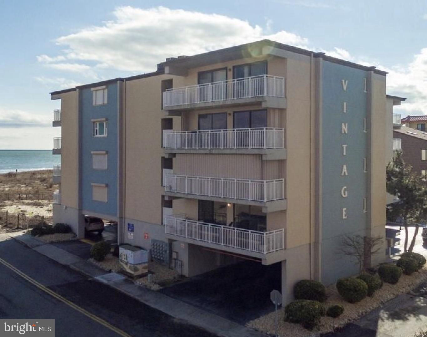 A rare find! An opportunity to own a unique condo that features expansive views of the ocean and shares no common walls with another condo, allowing for a wonderful cross breeze and quiet tranquility. The condo has been completely renovated, as was the building itself in 2017. Updated cabinets in kitchen and bathrooms, granite countertops, ceiling fans in every room, full sized washer/dryer and an enormous balcony that provides great views of both the beach and the bay. A new A/C condenser was installed in 2018 and new windows in 2017. The unit comes with a covered, assigned parking space. Located in family friendly midtown. Enjoy an uncrowded beach and no high rise buildings to block the afternoon sun. Walk to the market, mini golf, shops and many popular restaurants. This condo has not been rented and comes partially furnished. The HOA is currently $2401 a quarter, which includes a special assessment that has been collected during the past 4 years. The Board is expected to reduce the HOA during the annual Fall meeting. Prior to the special assessment, the HOA was $1200 a quarter.