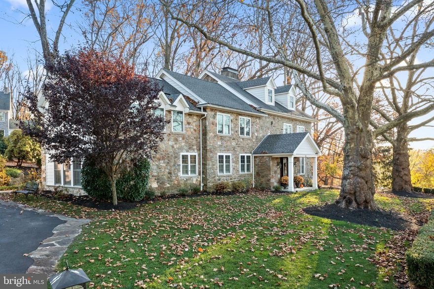 This classic Chester County Farmhouse is a perfect blend of the charm and elegance of a historic stone colonial but with a modern open floor plan and new everything! In 2015, this alternative to cookie cutter new construction was renovated top to bottom and enlarged - making the systems and finishes new while keeping the stone accent walls and all stone facade!  The impressive stately stone exterior and the established garden walk welcomes you into this stunning home.  Enter and original beams, deep window sills and gleaming hardwood floors showcase the pride in craftsmanship.  The living room features beautiful millwork, exposed beams, natural light and a gas fireplace.The dining room has a tray ceiling, dry bar with wine fridge and french doors accessing the flagstone patio with built-in firepit.  The large open kitchen with seated island features stainless steel appliances, gas cooktop, double oven, farm sink, subway tile backsplash and granite counters.  The kitchen is open to the adjacent morning room which has radiant heated floors for those chilly mornings and opens to the covered flagstone patio with restored original water feature.  The family room is a generous size with great light and a built-in window seat.  The powder room and laundry area complete the main level.  Upstairs the Primary Suite has a cozy gas fireplace, deep windows and a large bedroom area.  The primary bath features radiant heated floors,  two vanities, stunning shower with subway tile, ceramic accents and a private w/c.  The large walk in closet is custom outfitted with drawers and shelving.  The three additional bedrooms on this floor are spacious and all offer something unique. Bedroom 1 features a vaulted ceiling, tons of closet space and an en suite bathroom. Bedroom 2 has an original exposed stone accent wall and bedroom 3 has a large closet and vaulted ceilings. Bedrooms 2 & 3 share a large hall bath with double sink, linen closet and soaking tub. The third floor features bedroom 5/home office with a stunning exposed stone wall.  There is a roughed in bathroom and separate storage space on this level as well. Outside this .5 acre feels like much more as it overlooks the rolling meadow and mature trees on 2 sides maintained by the HOA.  The flagstone patio wraps around the house taking advantage of the open views and features a built-in firepit, koi pond and covered sitting area.  The detached 2 car garage is oversized with storage above. The lower level features a wine room and storage. All of this is located in the award-winning Downingtown School district, minutes to shopping in Exton and all major highways! If you are looking for the alternative to a cookie cutter, but still want all of the bells and whistles this home is for you!