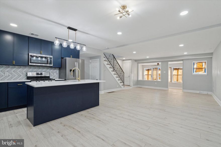 Step into this STUNNINGLY renovated 3 bedroom, 2 full bathroom home with a fully finished basement.
The main level welcomes you with a sunken front foyer bathed in natural light from its numerous windows, complemented by a ceiling fan for added comfort. The open living space features neutral flooring and  paint, flowing seamlessly into the modern kitchen. Enjoy sleek  blue cabinetry, a gas range, built-in microwave, dishwasher, and a double-door refrigerator complimented by an island with seating.  An exit door leads to the backyard and private four car parking, offering ultimate convenience.
Upstairs, you'll find three spacious, carpeted bedrooms, including a primary room with a ceiling fan. The full bathroom on this level features a walk-in shower stall, completing the perfect setup for comfort and style.
The lower level offers additional living space  / in law suite with a phenomenal full bathroom and another convenient exit to the backyard and parking. This home is move-in ready and waiting for its next owner!