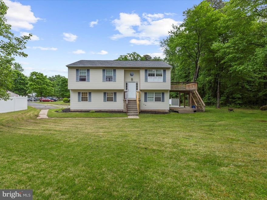 "HONEY--STOP THE CAR!" This 3 Bedroom/2.5 Bath Home on wooded lot is Ready To Go! Enjoy nature while sipping your favorite beverage on one of 2 decks, while watching deer graze right in your own backyard! The Main level hosts the Kitchen with Sliders leading to the upper level deck for outside dining.  This level also houses the Living and Dining Areas as well as 3 Bedrooms with New Interior Doors. The Primary Bedroom will easily fit your king-sized bed and has its own Private Full Bath and Walk-in Closet. The 2 secondary Bedrooms, with LPV flooring, share the updated Hall Full Bath.  Freshly painted lower level with BRAND NEW carpeting, the lower level is divided into 2 large living sections. The first side, features a free standing Woodstove in the Spacious Family Room to cozy up to during the colder months.  Sliding Glass doors leads to the lower level deck and into the backyard. (Or, use this room for a spacious 4th Bedroom setup!) A Half Bath and laundry are also part of this living area!  On the other side of the lower level, you will find a large Game Room/Play Room/ Bar Area.  There's a HUGE Wet Bar with Sink that is a Great Space for Entertaining and can easily fit 6+ barstools comfortably to watch any "Big Game".  Maintenance Free Vinyl Siding Exterior and a New(er) Roof (2021).  Situated on a cul-de-sac, this neighborhood is centrally located between Annapolis/Baltimore/DC and is sure to please! Available Immediately!