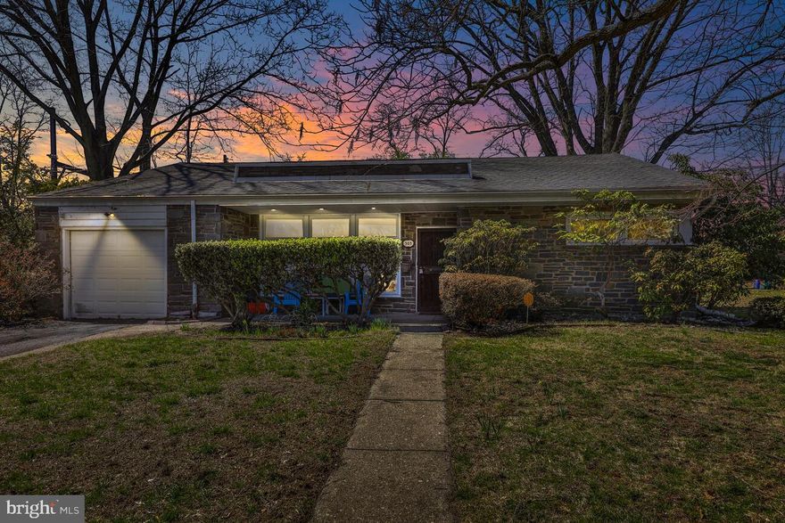 Mid-century modern one-story brick and stone home with many upgrades is deceptively spacious and airy inside. Enter into a huge living room featuring a floor to ceiling stone fireplace with mantel. Open plan leads to formal dining room, new kitchen with Italian tile floor and stainless appliances, and sweeps out to a magnificent flower garden, perfect for dining, playing and enjoying year round.  Backyard is fully green, perfect for pets and little ones, with flowering trees and backing onto Cresheim Woods (bird-watch and deer from the comfort of your chair!). Master bedroom with private full bath, plus three other bedrooms (one currently in use as an office), and full hall bath. Laundry room / pantry off kitchen is convenient and accessible, and there are plenty of closets. Pull-down steps to fully floored attic, great for more storage or could be converted to add additional room. Hardwood floors / Italian tile throughout, gas heat with newer furnace.  Many new windows let in great light, but house stays cool in summer with internal blinds. Located on quiet, wide street in desirable Mt. Airy, an easy walk to train, buses, or shops on Germantown Avenue, plus easy access to Chestnut Hill. Why wait?  Isn't this what you've been waiting for!