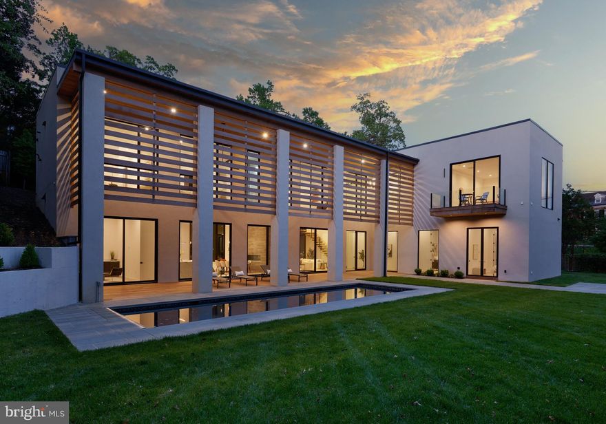 Contemporary Luxury in Massachusetts Avenue Heights<br>

Completed in 2024, this exceptional modern residence, designed by acclaimed South Florida architect Jeffery Silberstein, occupies a generously sized lot of over one-third acre in the prestigious Massachusetts Avenue Heights neighborhood of Washington, DC. A showcase of cutting-edge design and sophisticated finishes, the home is surrounded by curated outdoor spaces, including a heated 40' x 12.5' saltwater pool, expansive level lawn, natural Ipe wood decking, and elegant bluestone patios.<br>

Inside, interiors by JDM Design and ZDS Architecture & Interiors blend sleek modern aesthetics with seamless indoor-outdoor living. Lofty 12-foot ceilings, 10-foot doors, and floor-to-ceiling Marvin Ultimate windows allow natural light to pour in and provide effortless flow to the Ipe-covered loggia and poolside terrace.<br>

A dramatic double-height foyer introduces the main level, which features expansive living and dining areas centered around a bold 6-foot two-sided fireplace with lava stone and integrated LED lighting. The gourmet kitchen is a dream for entertaining, offering Thermador smart appliances, a custom island with leathered stone countertops, and a professional XO 42” grill.<br>

Additional main-level highlights include dual home offices, a private guest suite, a stylish pool lounge, and a climate-controlled two-car garage complete with a glass door, pet wash, mudroom, and second laundry zone. Radiant floor heating throughout the level is powered by a high-efficiency closed-loop Navien system.<br>

Upstairs, the primary suite offers a true retreat—featuring a spa-style bath with dual Toto bidet toilets, Mr. Steam shower, heated floors, and an expansive 17' x 19' walk-in closet with an adjoining dressing room and wet bar. Three more bedroom suites, a steam shower, and a full laundry room complete the upper floor, where 10-foot ceilings and automated window shades enhance both comfort and style.<br>

Notable features include:<br>

Western Red Cedar architectural accents<br>

Stucco exterior with Durarock-wrapped Zip System beneath<br>

Heated saltwater pool with auto cover (depths from 3.5’ to 8’)<br>

Custom floating steel staircase with 4” thick oak treads<br>

Five-zone HVAC system + independent mini-split in garage<br>

Closed-cell spray foam insulation throughout<br>

Tankless water heaters and a 26-zone radiant heating system<br>

Moooi designer lighting, Polk in-wall audio, and full smart-home wiring<br>

Custom tambour wood detailing in kitchen and primary suite<br>

Fluted oak slat wall paneling for a refined design touch<br>

Pre-wired surveillance camera system and WAN access points on both floors<br>

Every inch of this residence reflects intentional design and quality craftsmanship, offering an unmatched blend of contemporary style, comfort, and functionality in one of Washington’s most sought-after neighborhoods.