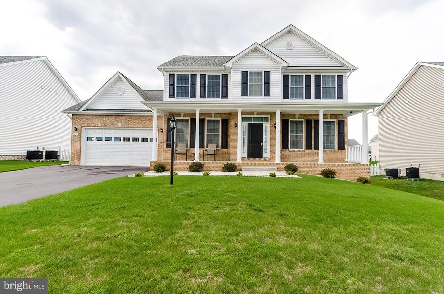 IMMACULATE Move in ready home, beautifully appointed with hardwood main level, upgraded stairs and rails, SS appliances, solid surface counters, front porch and 2 car garage sited on a great level lot. Paved drive and rear yard ready for your personal improvement.