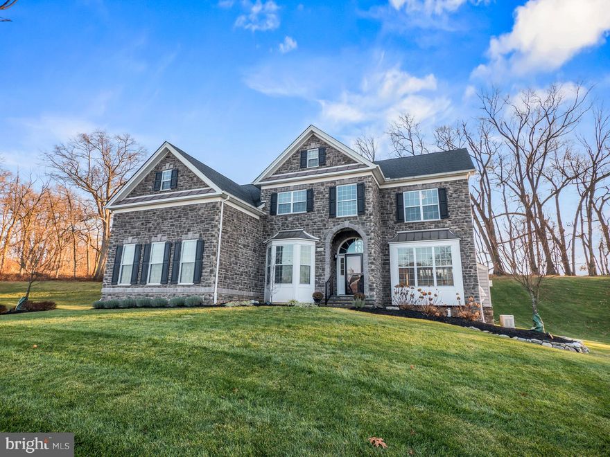 Experience the epitome of luxury living with this meticulously upgraded Columbia II model situated in the prestigious Weyhill Estates, just moments away from the Saucon Valley Country Club and Saucon Rail Trail. This five-bedroom, three-full-bathroom residence is a masterpiece that redefines opulence at every turn.  Approach this captivating haven through a grand exterior boasting a stately stone front, an arched entryway, and a generously proportioned TimberTech composite deck, complete with sophisticated lighting. Step inside, and the two-story foyer introduces you to the opulence that awaits, with Mannington engineered hardwood floors seamlessly gracing the entire first floor.  The living room is an elegant retreat featuring a gas fireplace, while the expansive dining room sets the stage for sophisticated gatherings. The first floor includes a versatile bedroom/office with access to a full bath, ideal for in-law quarters. The kitchen is a culinary marvel, adorned with a Tara Bianca Italian quartzite island and countertops, top-of-the-line Kitchenaid appliances, a double oven, a 6-burner gas range, a coffee station, and a pantry with custom shelving.  The bright and stunning breakfast area, with access to the deck, seamlessly connects to the great room, featuring a wood-burning fireplace, vaulted ceiling, an additional staircase.  Enjoy the convenience of the Control4 Integrated Sound and Video System.  The grand master suite on the second floor is a tranquil oasis, featuring a tray ceiling, a 19' x 11' custom walk-in closet with shelving and a closet island with his and her organizers by Creative Closets. The spa-like bath includes a spacious water closet, an extended dual sink vanity, a Stargaze soaking tub, and a tiled shower with dual shower heads and glass doors. Three additional bedrooms with spacious closets and ceiling fans, along with a full bath, provide ample space. The upper-level laundry room adds to the convenience.  The lower level presents an opportunity for your personal touch, roughed in for a full bathroom and wet bar. The three-car side entry garage features epoxy flooring with a polyaspartic topcoat, upgraded stone skirting, and custom lighting. Never worry about power outages with the 22KW whole house generator with a surge protector. LeafFilter gutter guards with a transferable lifetime warranty ensure worry-free maintenance. Located in the highly desired Southern Lehigh School District, this property is absolutely pristine, offering a lifestyle of unparalleled luxury and sophistication.  Exquisite home with immediate occupancy! Benefit from the advantage of a pre-listing inspection, ensuring the highest standards of quality. The sellers have diligently addressed and corrected any items highlighted in the original inspection report, offering you a seamless transition into your new home. Discover a plethora of upgrades that enhance the overall allure of this residence. Nestled in the perfect location, this 5-year-old home radiates sophistication and style. Why endure the wait for new construction when you can move into this stunning home right away? Don't miss the opportunity to make this dream home yours!