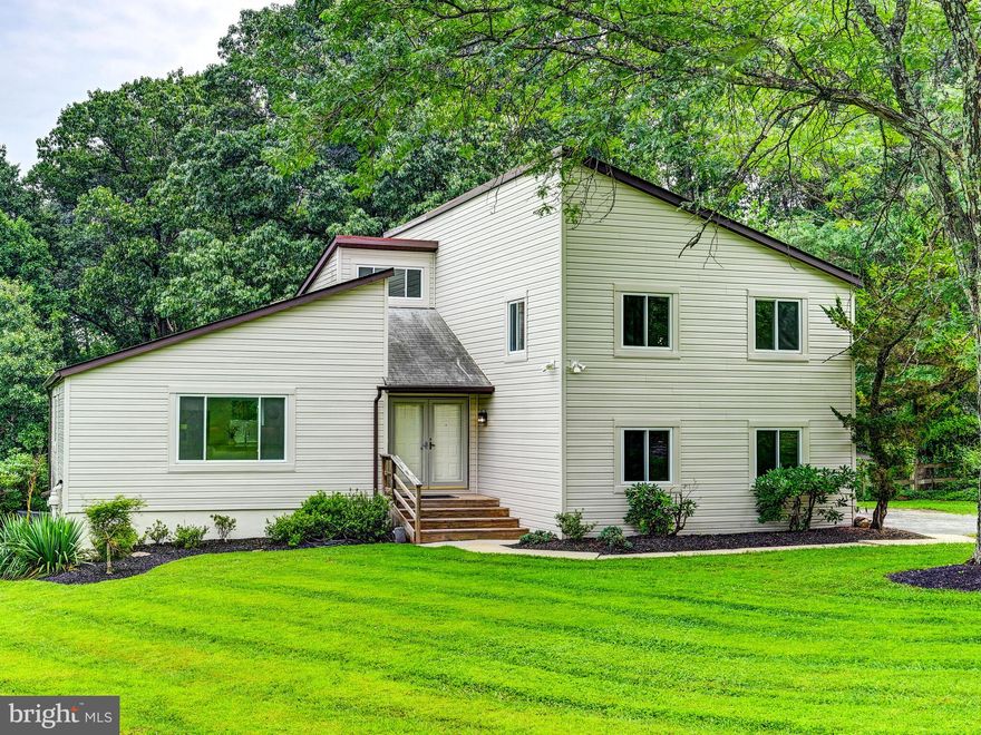 Contemporary style meets modern comfort in this beautifully updated 3 bedroom, 2.5 bath home with 1 car garage set on 1.75 private fenced acres. The open floor plan features a spacious great room that flows into the sleek kitchen with quartz countertops, a large island with pendant lighting & stainless appliances. The adjoining family room offers a custom built-in, recessed lighting & sliding doors to a rear patio- perfect for indoor-outdoor living. A convenient powder room & laundry room complete this level. Upstairs the freshly carpeted primary bedroom suite boasts oversized walk-in closets with built-ins & a luxurious bath with a seamless glass shower, rainfall & handheld shower heads & double vanities. There are 2 other bedrooms & hall bath on this level. The huge walkout unfinished basement is a blank canvas & can be created to whatever a Buyer prefers. Enjoy wonderful space, style & serenity.