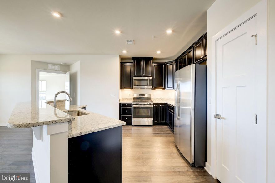 Embrace the convenience of a condo with all the comforts of home! Enjoy your own private 1 car garage & driveway, 1-level living with open design, gourmet kitchen w/ 2-tiered island, private covered porch, panoramic views from the primary suite, and so much more!  Included 5 inch engineered hardwood flooring, luxury tile, granite countertops, 42 inch cabinetry! Community features endless amenities truly resort-style living! Photos are representative