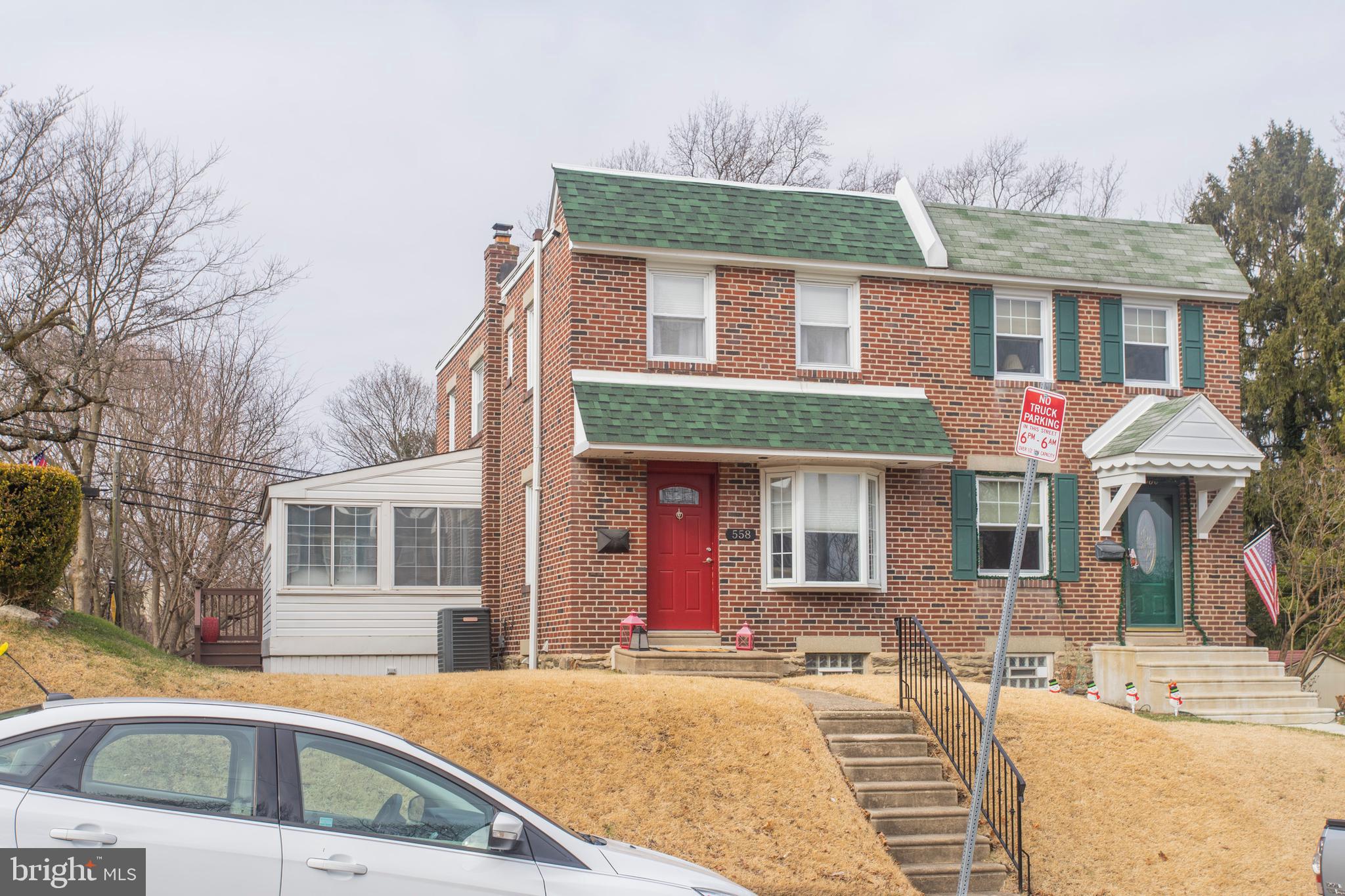 Showings start Friday! Wow! Welcome home to 558 Overlook Rd, a stunning 3-bedroom twin nestled in a quiet Roxborough neighborhood. If you are truly looking for a move-in ready home with off-street parking, this is a must see! From the moment you approach this home, you will fall in love with the classic brick exterior that will never go out of style. Step inside to the spacious and sunny living room. Original hardwood floors pop against the neutral paint, making it ideal for any decorating taste (or a blank canvas for those who love color). The beautiful hardwoods continue into the open kitchen/dining area. The wall between the kitchen and dining has been opened and a large breakfast bar added for additional prep and seating space. This layout is ideal for those who enjoy entertaining, whip up a feast while keeping an eye on friends and family! The kitchen includes newer cabinetry, recessed lighting, pendant lighting over the breakfast bar, tile backsplash, granite counters and stainless-steel appliances (gas range, built-in microwave, dishwasher and french-door refrigerator). Our favorite part of the home? The bright and sunny family room addition. This cozy space is perfect to use as a TV room or home office. The sloped ceilings include two skylights allowing loads of natural light to stream inside. The glass sliders lead out to the large, wrap-around deck. Add an outdoor rug, some potted plants and patio furniture, and get ready to enjoy your own outdoor oasis this spring! We foresee a lot of BBQs this Summer with guests being impressed with the private views of Wissahickon. All three bedrooms and full bathroom are located on the second floor. Each bedroom includes original hardwood flooring, and the main bedroom features beautiful crown molding. Is a finished basement a must? Check it off the list! The basement has been refinished into additional living space that can be used for a TV/Media room, playroom, home gym, you name it! The possibilities are endless. An additional half bath has been conveniently added to this floor, as well as the laundry and access to the private off-street parking. Enjoy being within walking distance to Gorgas Park and only 1.5 miles away from Main Street Manayunk’s restaurants, shops and nightlife. Why wait? Contact us today to schedule your private tour!