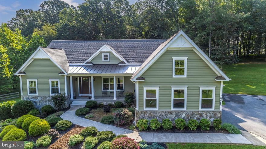 A true "almost new" custom home with style AND function? You have found it AND it is situated on one of the most beautiful lots in Western Howard County.  Attractive in appearance with its warm colors, stone accents and architectural features.  The property includes adjoining 1.78 acre forest conservation parcel to provide guaranteed privacy.  Total acreage is just under 3.  

Age in place with main level living as well as a full living space in the lower level for extended family, caregiver or simply additional income.

True gourmet kitchen with commercial grade appliances, custom cabinetry and a grand island for prep and entertaining.  Open floor plan yet still has defined spaces for formal and informal dining.  Great room with propane fireplace and oversized windows.   Three bedrooms and 2 baths on the main level.  Primary bedroom will pamper with serene views, 2 walk in closets and luxurious bath.   

  Lower level has full sized windows, a separate entrance and parking, full kitchen, bath and bedroom.   

A low maintenance deck with room for large gatherings including a corner outdoor fireplace and a view to mature woods.  

Located at end of a private road with 3 total homes.  Enjoy walks in the woods and along your private road.

HOA in place but no fees imposed at this time.