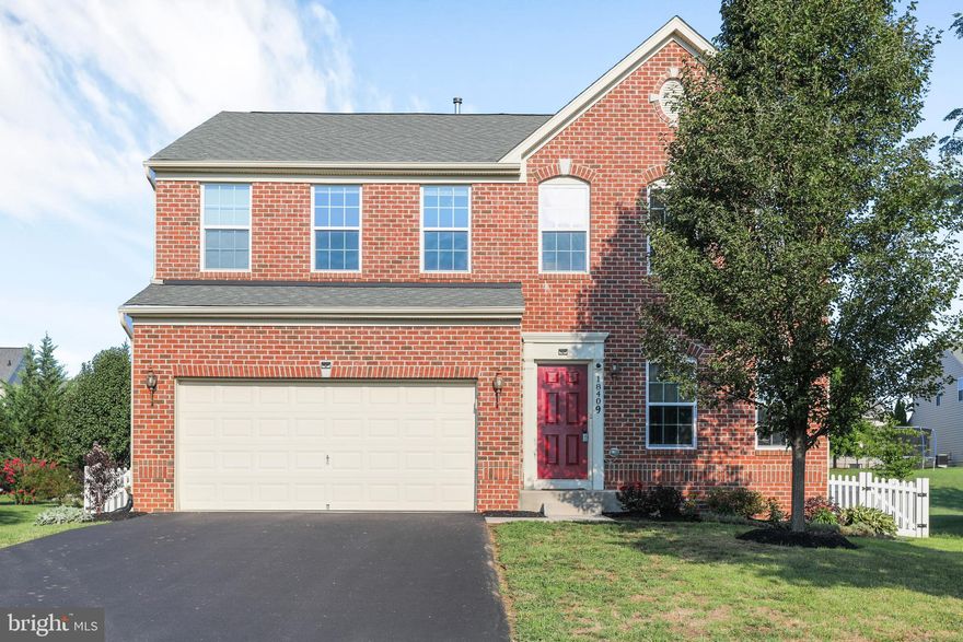 This beautiful brick front colonial has 4 large bedrooms, 2 full baths upstairs plus laundry room and a full finished basement on the lower level with a full bath.  The main level has a sitting room in the front of the home, just past the center staircase is the open family room, kitchen and dining room/sunroom.  The main level has beautiful hardwoods throughout.  There is a center island in the kitchen equiped with granite counter tops and a small mud room, coat storage just off the two car garage.  The sunroom opens onto the stamped concrete patio in your fenced back yard.  The walk up basement steps are inside the fenced area for privacy and security.  The interior staircase, upper hall and master suite is finished with hardwood floors and the master bath is complete with separate jet tub and glass surround shower. The decorative tile in the shower and tub area is beautiful and matches the tile floor.  The master en suite has a double sink with upgraded vanity top.  On the bedroom level is a large laundry room and the washer and dryer convey.  This home is located in popular Westfields and includes a community pool, sport courts and conveniently located to commuter routes, shopping, and dining.