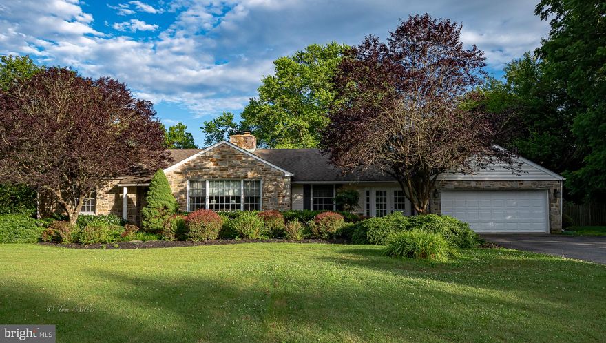 Beautiful stone rancher, level lot, fenced rear yard, landscaped, 1st fl. master suite with new bathroom and heated floors, opens to patio. Bright breezway with skylights between garage and kitchen, powder room off kitchen, large living room w/fireplace,Den/office off the kitchen, finished lower level with new carpet, walk up attic for extra storage, 2 car garage. New A/C unit,  Close to shopping, restaurants, great schools.