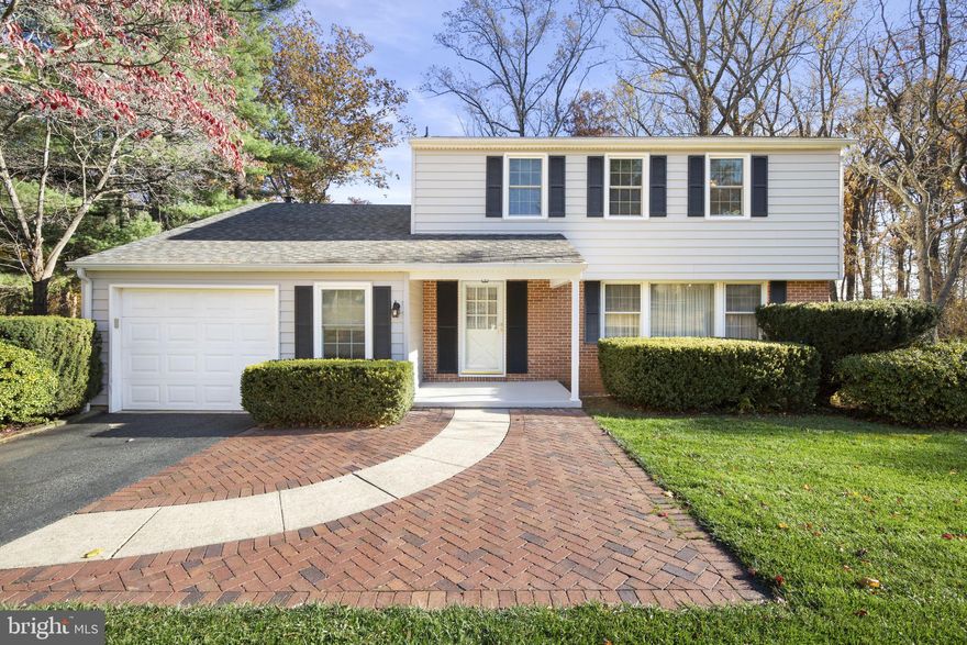 Welcome to this spacious 4-bedroom, 3.5-bath Colonial-style porch front home located in the desirable Fairway neighborhood of Bel Air. This beautiful home offers timeless charm and modern updates throughout, featuring a 1-car garage with attic storage and shelving. Step into the inviting foyer with a view of the wooden staircase and access to a half bath that conveniently leads into the main-floor laundry room.
The main level showcases gleaming hardwood floors, a living room with a picture window and crown molding, and a formal dining room enhanced with chair rail and crown molding. A bifold door opens to the kitchen, which includes dark cabinetry, a large island with seating, recessed lighting, two sinks, stainless steel appliances, two pantries, and table space—perfect for everyday living. Adjacent to the kitchen is the family room, complete with a brick-surround gas fireplace, built-in bookcases, and a six-panel glass door leading to the deck. The sunroom, with its wall of Palladian-style windows, fills the home with natural light and offers serene views of the backyard.
Upstairs, a spacious hallway leads to TWO  primary suites, each offering generous closet space and a private ensuite bath. The main primary suite features a walk-in closet, an additional double closet, and an ensuite with a dual vanity, tub/shower combo, and linen closet. The second primary suite includes its own full bath with a walk-in shower and ample closet space. Two additional bedrooms provide hardwood floors, ceiling fans, and double closets, while the hall bath is finished with a white granite sink, a black countertop, and a white tiled floor.
The lower level is partially finished and provides abundant storage and utility space. It includes a sump pump, a second refrigerator, a full-size deep freezer, two dehumidifiers, a generator, a French drain, a RainSoft system, and a laundry tub. You’ll also find a crawl space with shelving, a six-panel glass door leading to an additional basement area, double doors that open to the lower deck, and a walk-up exit to the rear yard, with stone steps guiding you to the front of the home.
Outdoor living is just as impressive, featuring a tiered deck with built-in benches on both levels, a flat yard that backs to woods, and a storage shed.
Recent updates include gutter guards, roof, addition, HOOT septic system, Trane HVAC, updated bathroom vanities, primary shower, fireplace, reverse osmosis water system, and refinished hardwood floors.  The siding includes a lifetime transferable warranty. 
This home offers exceptional space, thoughtful updates, and a peaceful setting—ready for you to call it home!