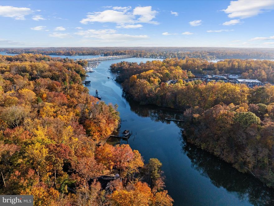 WATERFRONT home nestled on nearly two acres and over 300 feet of pristine water frontage along the Gingerville Creek! This property is more than just a home—it's a retreat where every day feels like a vacation! As you approach this tranquil residence, extensive hardscaping and elegant outdoor lighting greet you, creating a warm and welcoming ambiance. The beautifully landscaped grounds, enhanced by an irrigation system, provide a picturesque setting for family gatherings or peaceful moments enjoying nature. Step inside to discover a thoughtfully designed layout that seamlessly blends comfort and style. The main level features a spacious primary en-suite, spa like bathroom beautifully tiled with dual vanity sink and dressing table, heated floors, walk-in glass shower, and incredible walk-in closet...complete with private access to a screened porch—a perfect spot to unwind with a good book or enjoy your morning coffee while soaking in the stunning views. Two cozy fireplaces add to the inviting atmosphere, providing warmth and charm during cooler evenings. 
The gourmet eat-in kitchen is a chef’s delight, showcasing a large island, stainless steel appliances, and expansive windows that flood the space with natural light. Glass doors lead to a rear deck overlooking the tranquil waters, perfect for outdoor dining and entertaining. The spacious living area flows effortlessly into additional recreational space on the lower walkout level, where you’ll find two more bedrooms, a laundry center, and a full bath with a luxurious steam shower. Venture outside to your own personal paradise. The screened porch is ideal for watching your favorite games, while the fire-pit invites you to gather under the stars, sharing stories and laughter with loved ones. Stroll through the terraced gardens, each step revealing the beauty of nature surrounding you. For boating enthusiasts, a covered slip with a 20,000 lb boat lift awaits just steps from your door, offering quick access to the South River, Chesapeake Bay, and beyond. Your adventures on the water are only a moment away! Privacy and serenity are paramount here, making it the perfect escape from the hustle and bustle of daily life. Additionally, a detached 720 sq. ft. garage provides a separate entrance to an upper area that can be transformed into an in-law suite, home office, gym studio, or game room—let your imagination guide you! Situated in close proximity to Historic Annapolis, you’ll enjoy the best of both worlds: a peaceful retreat with easy access to vibrant city life. Excellent location for commuting with easy access to Rt 50 and 97, tons of shopping options, restaurants, doctors/medical offices, the library, county parks and South River blue ribbon schools! Come experience this waterfront oasis on Gingerville Creek and make it your new home!