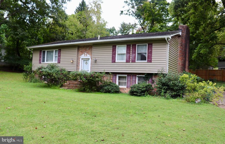 Amazing opportunity in the heart of Mount Washington! Tucked away at the end of a quiet dead-end street, this 3BR/3BA split foyer home is full of potential and ready for your vision. The upper level features a spacious living room, dining room, a primary suite with attached bath, an additional large bedroom, and a hall bath. The kitchen overlooks a stunning 400 sq ft addition with walls of windows and peaceful views of the private, tree-lined backyard. Most of the main level, including the addition, features solid hardwood floors just waiting to be refinished. The lower level offers a large family room with a massive brick wood-burning fireplace, plus a third bedroom and full bath. Home is being sold strictly as-is; inspections are for informational purposes only. Bring your ideas and restore this home to its former glory in one of Baltimore’s most desirable neighborhoods!  Please note: The sellers will be removing select personal items prior to settlement; however, the majority of the contents in the home will remain and convey with the property.
