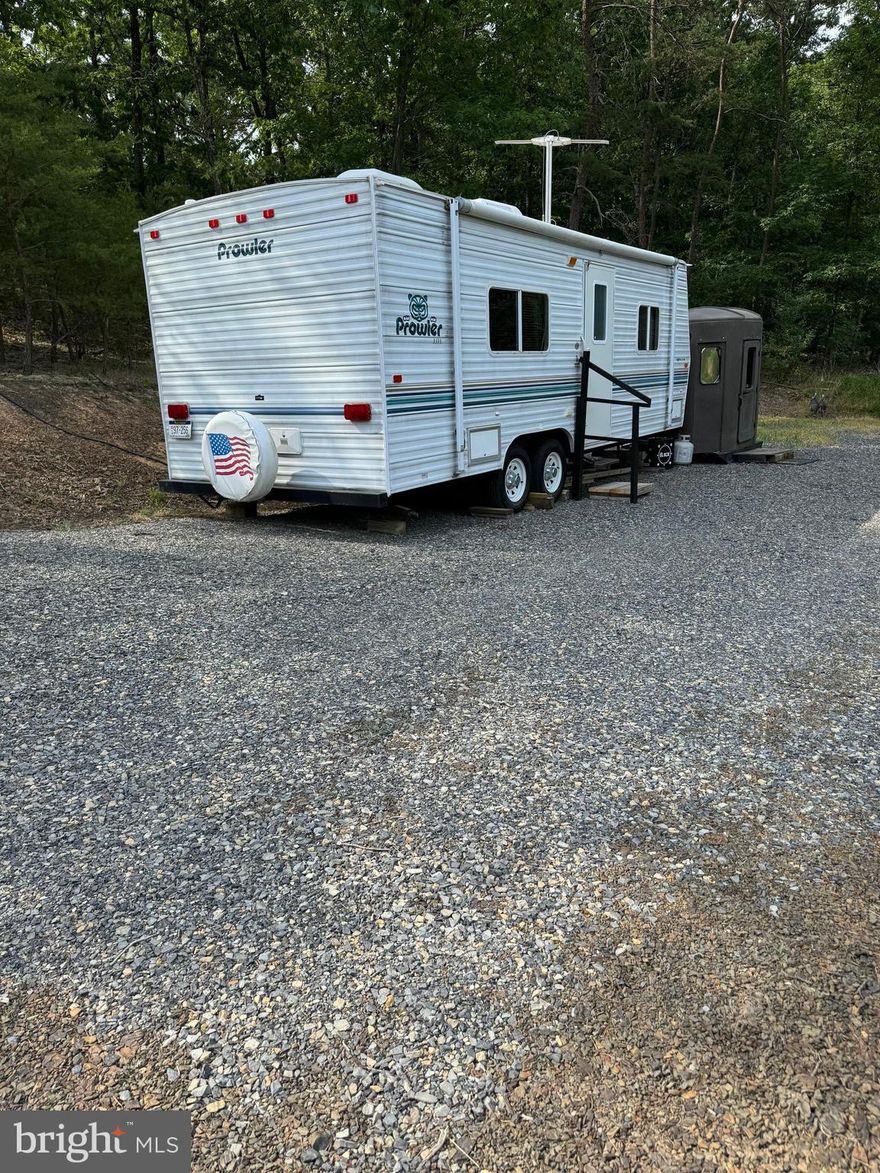 Unrestricted parcel with excellent access.  Located directly on corner of Rt. 220 and AJ Kelley Road.  Electric and driveway.  Property includes a 2003 Prowler 25 ft. camper.   Great lot to build a weekend cabin or a permanent home.   Start your weekend getaways in the 25 foot camper with AC.  Private lot with easy access to US 220.  Plan a visit to enjoy the location.