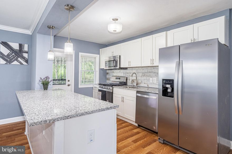 PICTURE PERFECT END OF GROUP RENOVATION WITH 3 FINISHED LEVELS!  Features include an open floor plan with wood floors throughout the main level, spacious living room and separate dining area with crown moldings, designer kitchen with granite counters, ss appliances, and mosaic backsplash, upper level with 3 bedrooms and 1 full bath, finished basement with a large family room, and a half bath, and  a large fenced yard.  Pack your bags and move right in!