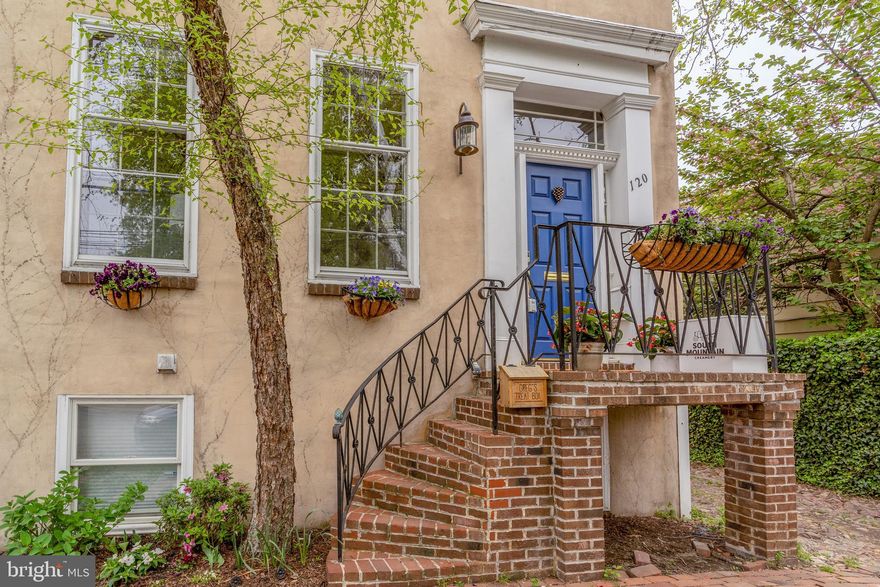Welcome to this lovely home with soaring ceilings, five wood burning fireplaces and classic charm! Built in 1976 to replicate the historic homes of Old Town, this home exudes character but offers modern conveniences. The main level is a large open space for living and dining complete with two wood burning fireplaces, custom built-ins and crown moldings. The adjacent Butlers pantry offers lots of storage, dishwasher, sink and 2 beverage refrigerators. Downstairs you will find the renovated eat-in kitchen with climate friendly induction range. This large space has historic brick floors and a wood burning fireplace. There are two bedrooms and one bathroom on this level. Upstairs you will find two generously sized bedrooms each with their own wood burning fireplace and renovated bathrooms. The large primary bath includes a double vanity and a stand up shower with glass enclosure. The renovated hall bath has a wonderful soaking tub. The top floor is an amazing space that can be used as an additional bedroom, home office or game room. The classic double porches offer a magnificent view of the landscaped rear yard. Two surface parking spaces are directly outside the back gate. Located just off King Street, this charming oasis is walkable to the restaurants and retail of Old Town.
