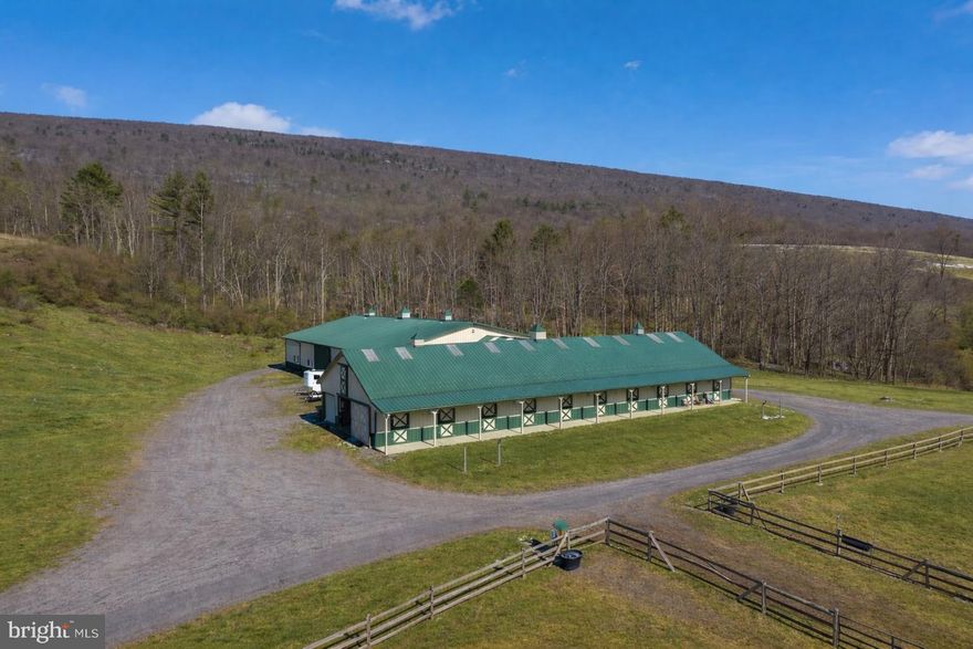 Rare 204-acre equestrian estate featuring a modern 12-stall horse barn with wash bay, tack room, feed room, and upper-level hay storage, along with 39 acres of pasture divided into six paddock. Training facilities feature an 80'×120' indoor riding arena and a large outdoor arena. The land offers approximately 58 acres of tillable ground and 133 acres of woodland, creating an excellent mix of agricultural use and recreation. Ideal for a private equestrian estate, training or breeding operation, or agricultural investment.