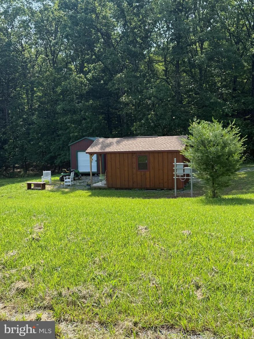 Looking for a weekend getaway or a spot to connect your camper? Look no further! This property boasts over 3.5 acres, featuring a well, 200 amp electrical service, and camper hook-up facilities. Additionally, there’s a garage for storage and an unfinished cabin already equipped with electricity.  Septic drawing on file with county. It’s all set and waiting for you—what are you waiting for?