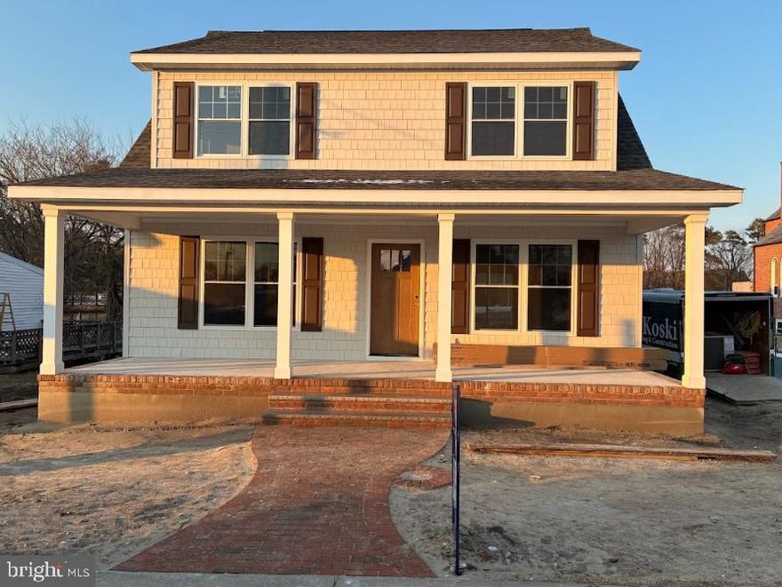 Welcome to this beautifully crafted two-story Cape Cod home, perfectly situated at the end of a quiet road in the highly sought-after town of Vienna, MD. Offering both privacy and charm, this location provides a peaceful setting while still being close to everything the area has to offer.
This thoughtfully designed home features 4 bedrooms and 2.5 bathrooms with a functional and inviting layout. The first floor offers an open-concept living and dining area, ideal for everyday living and entertaining. The kitchen flows seamlessly into the main living space and is complete with stainless steel appliances and elegant quartz countertops. A convenient half bath and a dedicated laundry and mudroom add to the home’s practicality.
The primary suite is located on the first floor and includes spacious walk-in closets and a private en-suite bathroom featuring a quartz-topped vanity and a beautifully tiled walk-in shower. Upstairs, you’ll find a large family room with vaulted ceilings, creating a warm and inviting second living space. Three generously sized bedrooms, each with walk-in closets, along with a full bathroom featuring a tub/shower combination and quartz countertops, complete the upper level. Additional highlights include oak tread stairs, a welcoming front porch with brick row lock detailing and brick steps, as well as a back and side stoop for added convenience.
This home is currently under construction. Get in early and have the opportunity to select some custom finishes and make it your own. Builder is offering a one-year home warranty for added peace of mind.

**Photos attached are of a previously built home of the same floor plan and are for layout and reference purposes only. The exterior photo shown is a model home and not the exact home being constructed at this address. Additional photos will be added as construction progresses.**