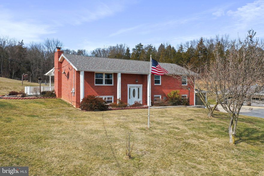 Country living at it's finest!  This incredibly well-kept split foyer is perched on 2.74 acres of the best of West Virginia with sweeping views of the mountains of "Almost Heaven."  Opportunity is limitless with this much space at your fingertips.  Whether the outdoors are calling your name or you want to spend your time nestled by the fireplaces inside, this home has something for everyone.  Windows and roofing are just a few of the many very recent updates on this one.  There's a large 2 car detached garage and a massive RV-sized carport for extra parking and storage.  As an added bonus, there's actually a site/pad that was used for a mobile home on the property that is ready to roll for you to add a second living structure.  Public water is here!