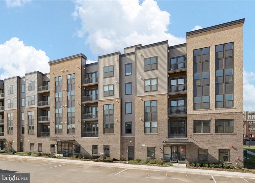 Welcome to The Flats at Waxpool Crossing – a vibrant New Luxury Condo Community.  Be the very first to call this stunning, just completed condo home! This never-lived-in residence showcases high ceilings, luxury vinyl flooring throughout the main living areas, and plush carpet in the bedrooms for added comfort. The open-concept kitchen features a show-stopping countertop with extensive prep and serving space, a beautiful backsplash, upgraded energy-efficient stainless steel appliances, and ample storage.
Both bedrooms are generously sized, and the two full bathrooms offer bright finishes, stylish tilework, and plenty of space. Enjoy the convenience of in-unit laundry, abundant natural light, and a quiet, airy atmosphere throughout. Included with the home is garage parking space #1, which is covered and secured with fob access, as well as storage closet #34 located on the ground level. The building offers secure fob entry leading into a welcoming social area complete with a pool table and amenity space. Residents also have access to a charming dog washing station, conveniently located near the mailroom and garage entrance.
Outside, enjoy beautifully landscaped common areas featuring tot lots, a dog park, pavilion, and sports courts — perfect for relaxation and recreation alike. This condo offers the perfect blend of modern luxury, comfort, and community — all in a brand-new, move-in ready package! Located in highly sought-after Ashburn. The Flats at Waxpool Crossing offers easy access to major commuting routes such as Rt. 50, Rt. 7, and VA 267. You'll also discover dining, grocery stores, and shopping options, including One Loudoun and Dulles Town Center just minutes away.  Enjoy the perfect mix of modern conveniences and community charm living in a vibrant, growing area!