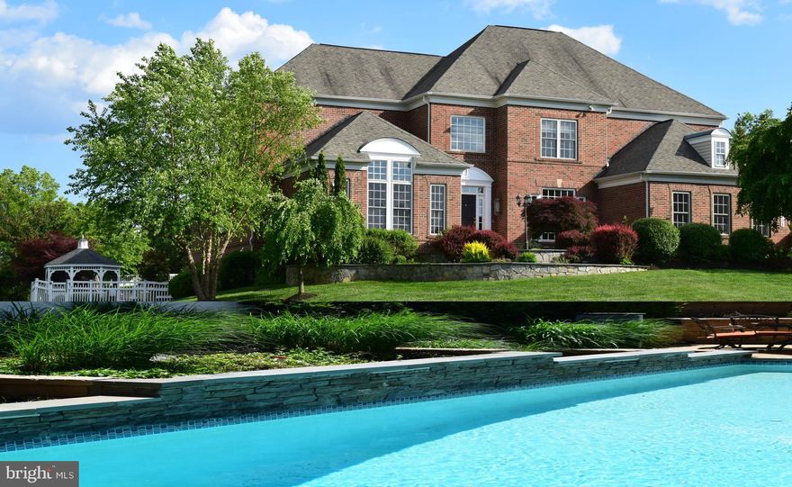 Beautifully designed 3-sided brick colonial situated on over an acre in Western Howard County with over $300K of upgrades! Enjoy work from home in this stately colonial with over 7,000 square feet of open concept living with formal grand room and dining room, large center island, 42-inch cherry wood cabinetry, granite counters, SS appliances, and butler pantry. Grab a work out in your 750 square feet commercial Gym then relax by your 50 feet gunite salt water pool with an in ground cleaning system. Watch newly released movies on your 120 inch 4K projection Screen! YES IT IS ALWAYS OPEN for your enjoyment. Owner is agent. Many updates over the last 3 years: New Roof (2019), water heater (2016), new water treatment system (2019), new main HVAC (2019), new master bath and buddy bath (2016).