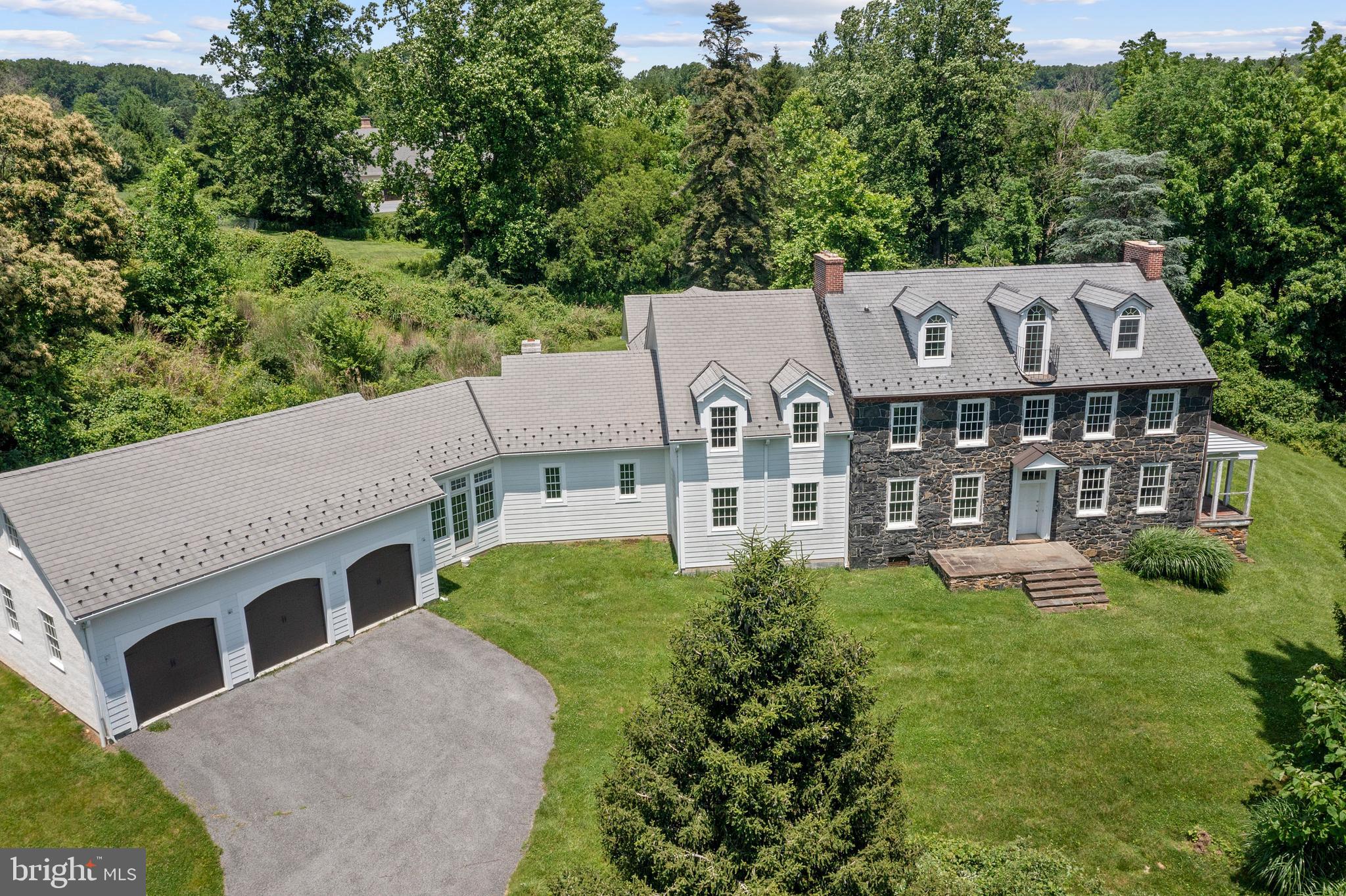 Saying 453 Bayard Rd is a historical gem of a property would be the understatement of the century! More affectionately known as the "Flower Farm"-The deed for this property can be tracked all the way back to William Penn in the 1700's-when it was a 515 acre parcel. Then granted to Joseph Pennock another famous name in KSQ-in 1701. The history is so rich with influential names, that we encourage any potential buyer to please reach out for more information with the listing agent. We have an entire binder of information from the original developers that we would love to share. It is believed reviewing the 1850 census the first structure on this tract of land was erected in the 1840's by Thomas Marshall Jr. for his bride- a widow Elizabeth Plankinton Sinclair. Thomas who was a Quaker was "read out of meeting" for his transgression of marrying a widow-but love overcame and he created this beautiful historical property standing today. Built with hornblende stone from a quarry on Hillendale Rd-the exterior of this home is timeless and breathtaking. The home sits atop the hill with miraculous views, and overlooks the massive 3 story barn. It is worth noting the barn has had significant utility & structural upgrades. The barn was in the process of being finished for livable space by the current owner. The best way to describe the home would be once you walk inside you take a magical step back in time-to incredible detailed craftsmanship. Once in the "old part of house" you can enjoy 3 stories of living, 4 bedrooms, 3 full bathrooms and a half bath. The loft/4th bedroom all the way upstairs features its own full bath and has amazing views of the property. The old part of the house is over 4000 plus sq ft of living space and has history tucked around every corner. All the systems have been updated to today's standards, including new electrical panels, and a high velocity hvac. In the study, or old kitchen downstairs you can cross over into the 4000 plus sq ft new addition portion of the property. From the old house walk into the family room, and then the massive kitchen- with 20ft plus ceilings with tremendous detail like barrel rolled arches, and high end tile. Off the Kitchen there is a walkway overlooking the soon to be courtyard- that leads back to the primary suite. Radiant heat floors in the entire primary bed and bathroom. There are also two closets, separate washer dryer hookup, massive shower area, and a dedicated room for vanities and toilet to name just a few of the great features in the primary suite.. On the other side of the addition there is a breakfast room, utility room for washer dryer hookups, and also an option for a great guest quarters with its own staircase that could serve as a 6th bedroom also. All the way downstairs there is an absolutely MASSIVE basement with 9ft ceilings and endless possibilities. This property truly has it all. Historically significant for sure, with new world amenities for the modern buyer, the best of both worlds. Bring your vision and contractors to finish the blank canvas kitchen and other finish work to make this proeprtry one of the top show pieces in all of Kennett Township. Many structural upgrades include outside french drain, storm water management in place, new septic that has never been used. New 50 yr shingle roof, new steel roof on the barn, Geothermal HVAC systems. Approximately 8000 sq ft of living space in the house , plus 3.11 acres and a 3 story barn with structural upgrades means the value is here. "AS IS" and CASH sale only- and this is a project- the last 25 percent of cosmetic choices, the kitchen, and finish work needs to be completed, a perfect opportunity for someone with vision. Tremendous upside to make this a 2 million plus property in one of the most desired townships in all of Pennsylvania!