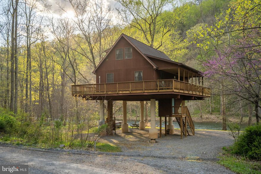 River's Edge!! Stunning setting for this Spacious Chalet, view the river from every window and the beauty will astound you.  2 bedrooms, loft , 2 full baths, great room with wood burning stove, well designed kitchen, Even a electric deck hoist for bringing up the groceries. Wrap around deck & covered porch. The fire pit at the beach will provide hours of relaxation after a day on the river, swimming, fishing and kayaking,  This home was designed for the family retreat, make your appointment today!