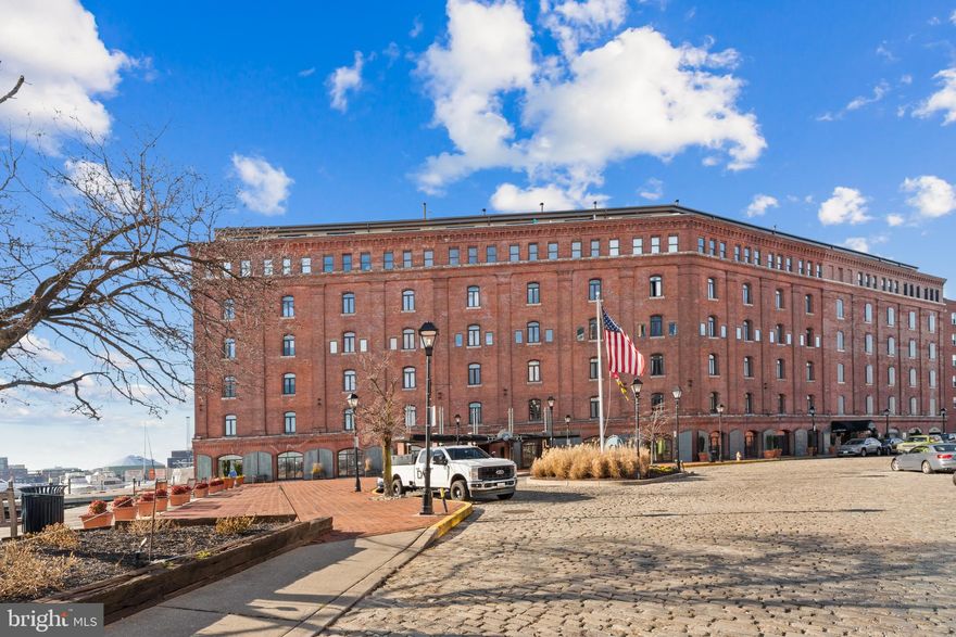 Chic 2-level condo in Baltimore's historic waterfront Henderson's Wharf. Totally renovated 1 BR 1 BA open concept W/Custom Kitchen, Hardwood Flooring, Custom Plantation Shutters that open to stunning sunrises on the water. Upper level boasts huge BR, Laundry, Custom Closet Systems. There is a beautiful lobby with common areas, gym, 24 hour Concierge/Security, and one deeded parking space in the garage closest to the 4th floor entrance. Imagine yourself home, as you stroll along the waterfront in charming Fells Point.