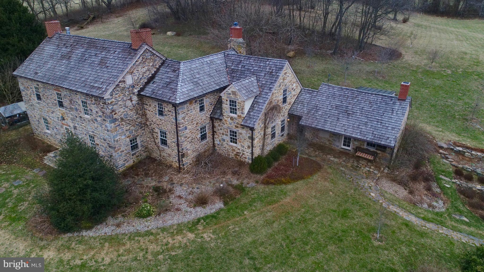 Gorgeous 1820, 57-acre historic stone property has 7 FP, orig ceiling beams, new 2-car garage, guest house, Bank barn & heated commercial greenhouse. (completely renovation 2012) with many high end finishes. Plumbing, wiring, HVAC, baths, kitchen, oil storage tanks completely replaced w/ new equip. This home has a outdoor wood furnace option that heats the entire property. Whole house generator.