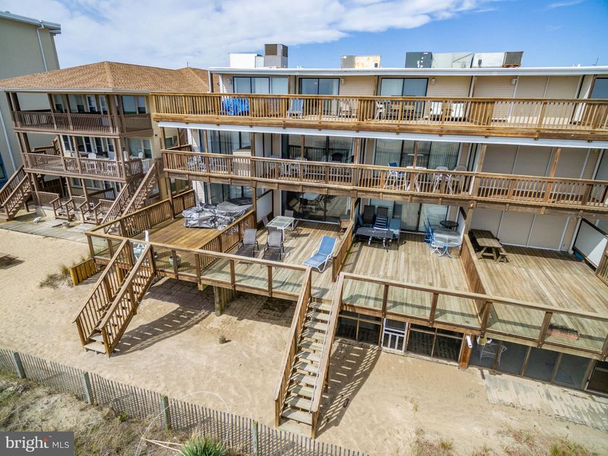 HARD TO FIND DIRECT OCEANFRONT 5BR  4BA  TOWNHOUSE! You can enjoy 3 oceanfront decks with great ocean views! You can also walk right out to a private sandy beach area! The 1st floor features a  bedroom/living area with a full bath and direct access to the beach! The second level features the living room , kitchen and dinning  area and a bay side bedroom and full bath. The large deck off the living room is a fantastic family gathering area with ocean views and stairs directly down to the beach! You can relax and sun bath during the day and look out over the ocean under the stars at night! The 3rd floor features an oceanfront master with another spectacular oceanfront deck  and a 4th bedroom on the bay side! The 4th floor adds that 5th bedroom on the oceanfront , a full bath and another Oceanfront deck with panoramic views up and down the beach! This oceanfront townhouse is perfect for a large family looking to create ocean memories that last forever!  It has also been a fantastic rental $50,000 in gross rental income in 2019! This is a unique opportunity and a "Must See Porperty"!