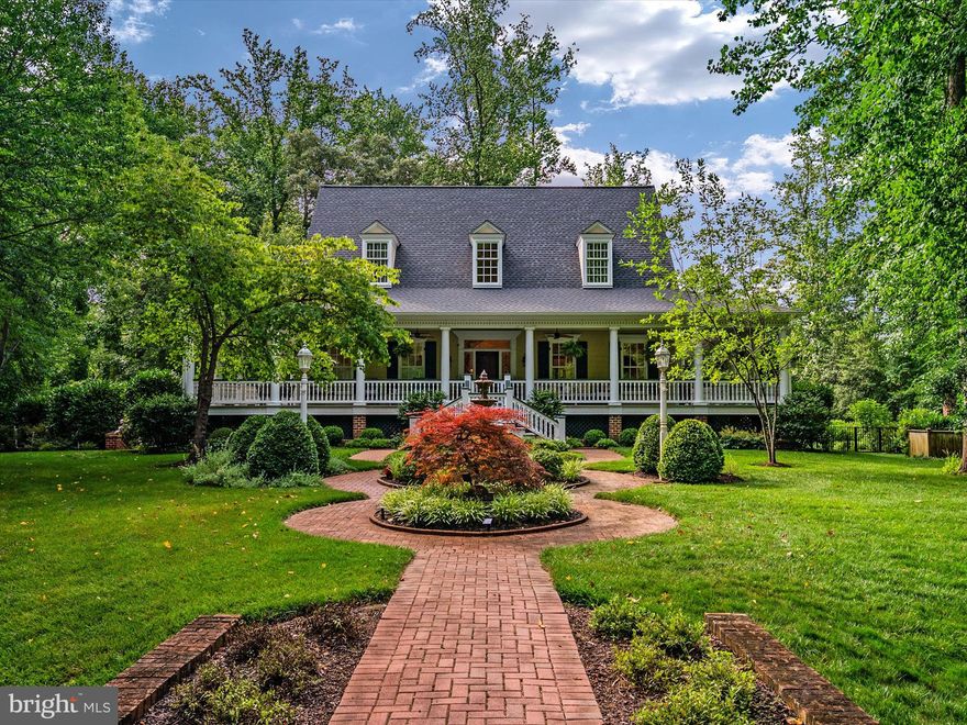 This custom built, three level southern colonial is situated on a beautifully landscaped 1.9 acres in the sought after Cherrystone Community. The elegant exterior of this home features a FOUR-SIDED WRAP AROUND PORCH and a lovely courtyard with brick walkway and 3-tiered fountain.  As you enter the home you will be welcomed by the impressive two-story foyer with gleaming oak floors that continue throughout the first level. The detail in this home and amazing craftsmanship is like no other. Throughout the home each room is enhanced with dramatic architectural detail, including soaring cathedral ceilings in the great room, eight-inch dentil crown molding, built in bookcases, and skylights to name a few. The great room has a gas fireplace and french doors out to the porch. The kitchen  was remodeled in 2022 and is a chef's dream with high end appliances that include a WOLF 6 BURNER STOVE WITH DOUBLE OVENS.  The kitchen boasts quartz countertops, upgraded accent lighting under the cabinets and the base boards, custom cabinetry, skylights as well as french doors that exit onto the WRAP AROUND PORCH that is steps away from the extraordinary pool and outdoor space.  The first-floor primary bedroom is a tranquil retreat with a gas fireplace, built-in bookcases, recessed lighting,  skylights with motorized shades and his and hers walk in closets. The primary bathroom was recently remodeled in 2022 to include a magnificent chandelier, custom floor to ceiling shower and separate custom vanities. The upstairs of the home is perfection with two-bedroom suites, each with an en-suite bath, dressing room and walk-in closets. The lower level of this home features an additional bedroom suite with its own bath and separate entry.  Perfect space for an in-law suite or au-pair suite. The lower level also features an EXERCISE ROOM, MEDIA ROOM AND WINE CELLAR that holds 500 bottles of your favorite wine.  As you walk out to the back of the house the real showstopper is the magnificent HEATED SALTWATER POOL that owner installed in 2019. From the latest technology to exquisite enhancements, this swimming pool boasts significant upgrades that make it an exceptional pool experience. The luxurious landscaping and hardscaping that surround this property is exceptional.  Additional features of this home include NEW ROOF 2023 with 50-year warranty, two car garage with built in cabinetry and ample storage space under the porch area, three zoned heating and air conditioning, main level unit replaced 2023, NEW generator 2023, and Attic Fan 2023. This is a one-of-a-kind custom home that you have been waiting for in Annapolis. Property is minutes from downtown Annapolis, 30 min to DC and BWI.  HOME WARRANTY included